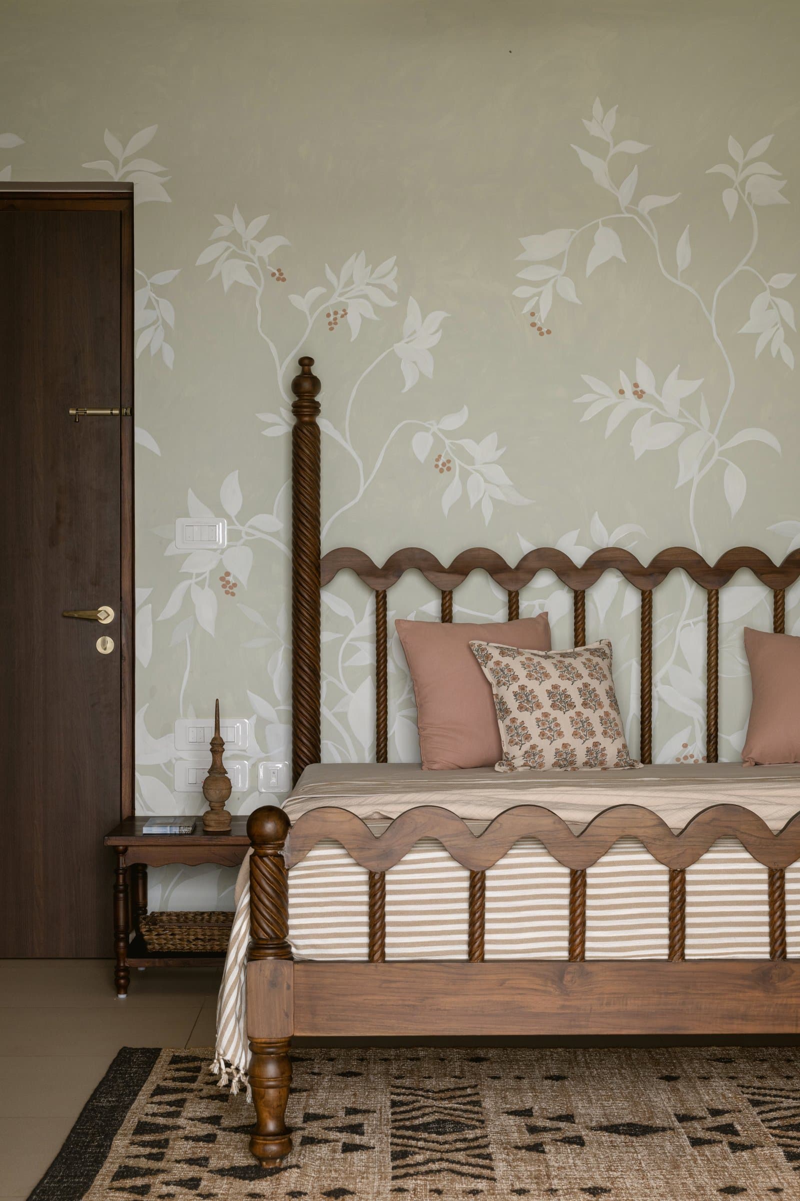 The river-facing bedroom, where a scalloped four-poster and soft green wallpaper set a warmer register