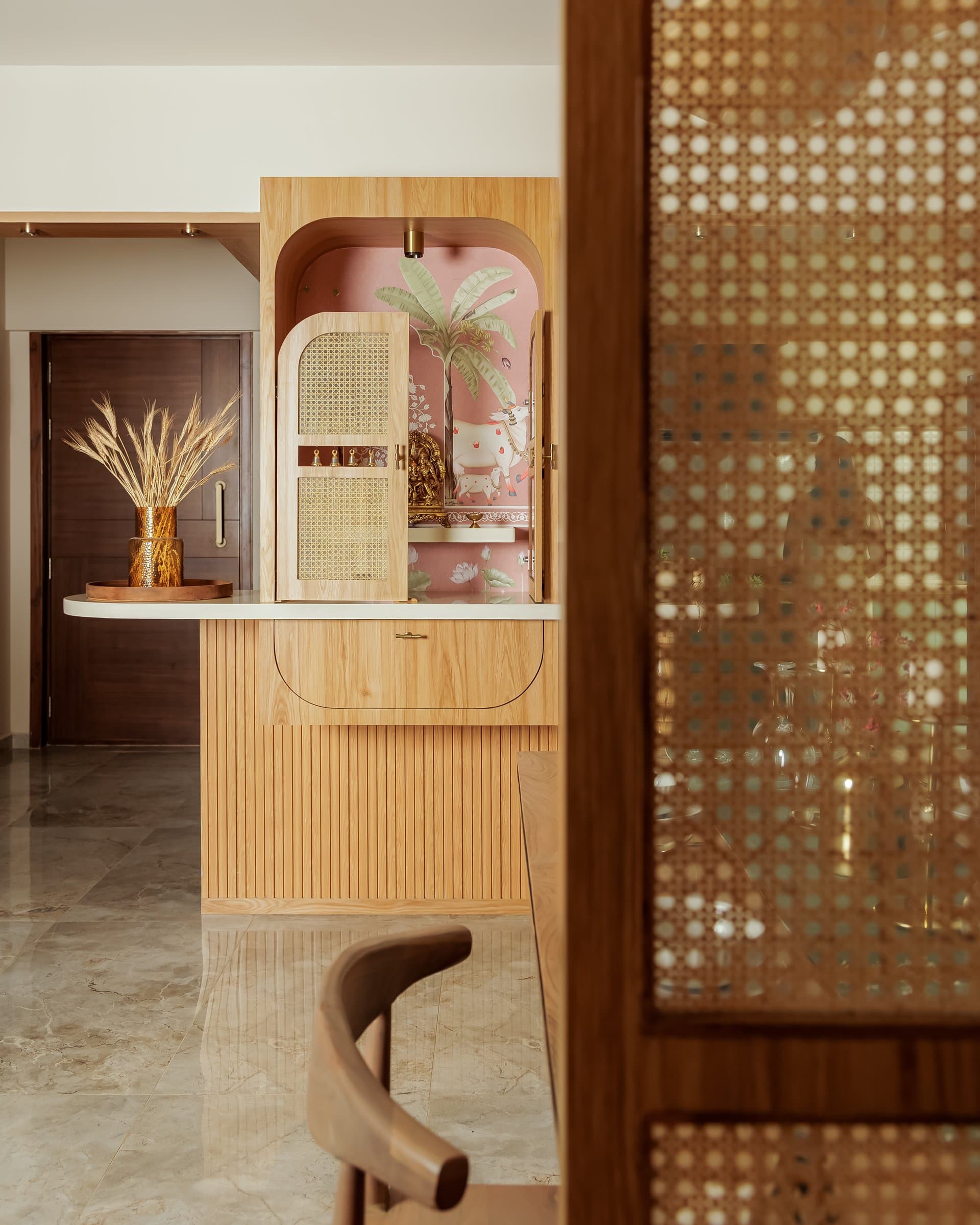 The pooja unit, its cane-front shutters allowing the shrine to remain part of the joinery when closed