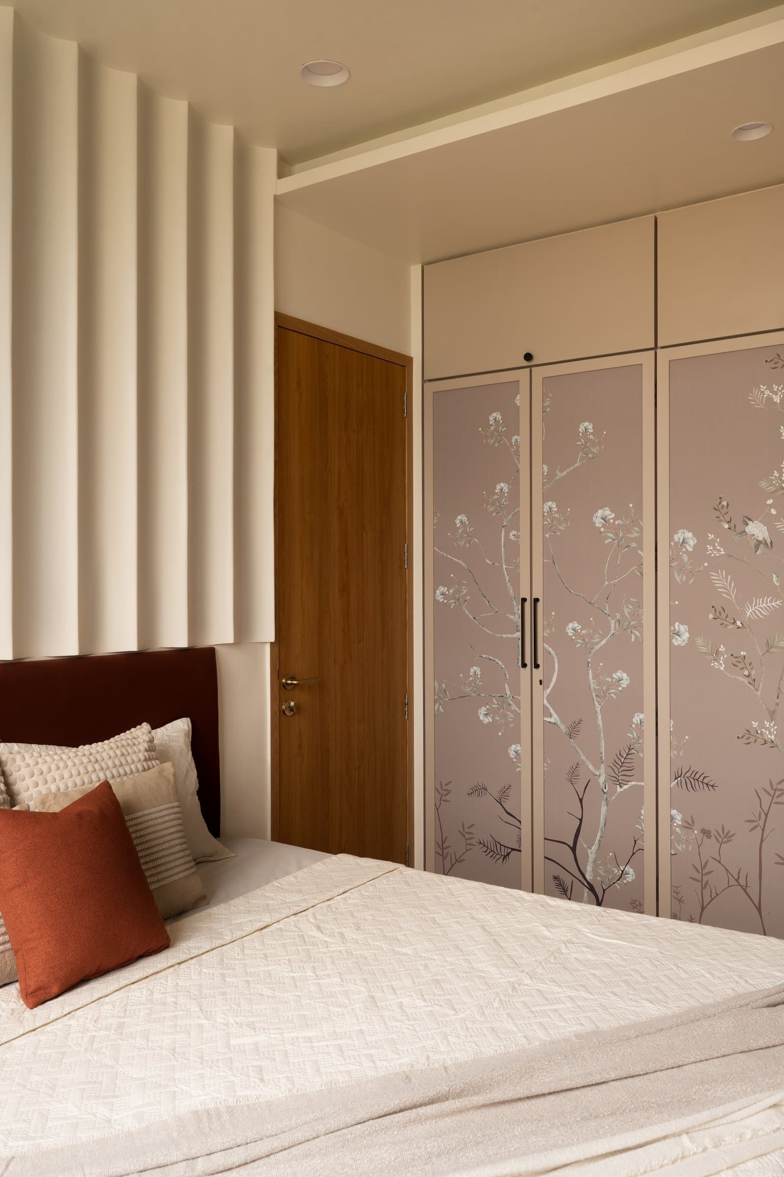 The primary bedroom wardrobe, its chinoiserie-style botanical print giving the suite a layered focal point