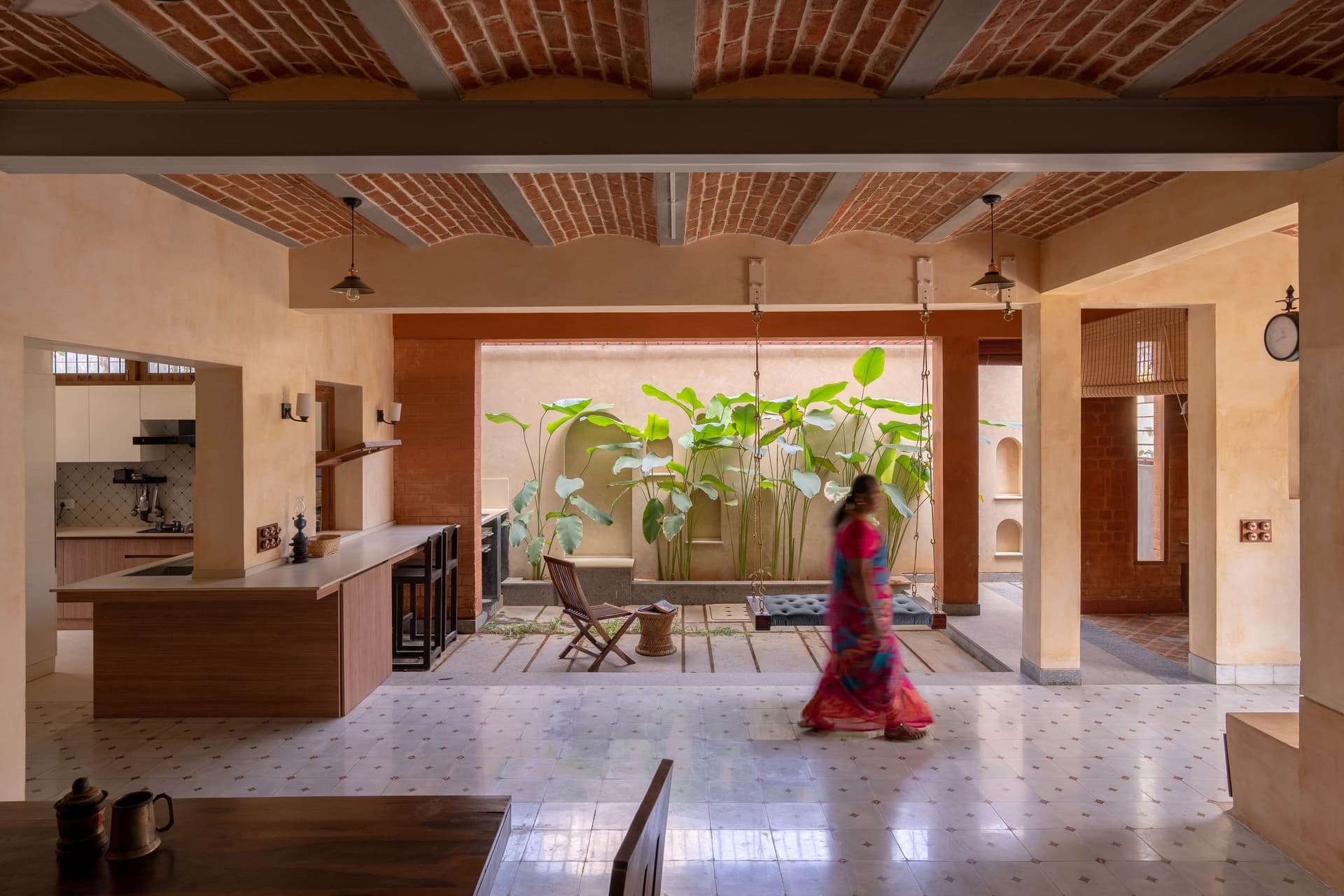 An internal courtyard planted with tropical foliage brings weather and light into the plan