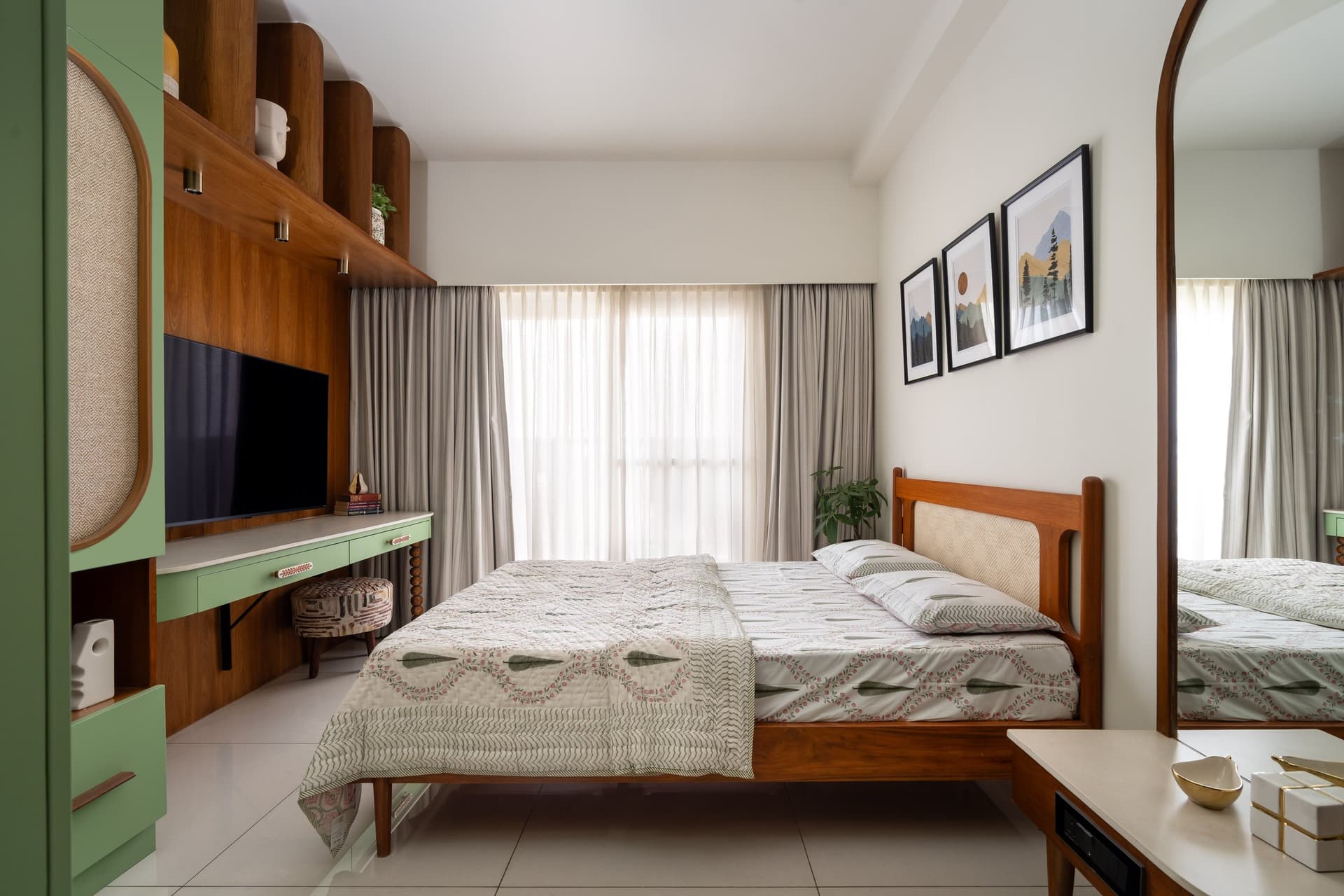 The sons' room, where a cane-inset teak bed sits beneath a trio of muted mountain-scape prints