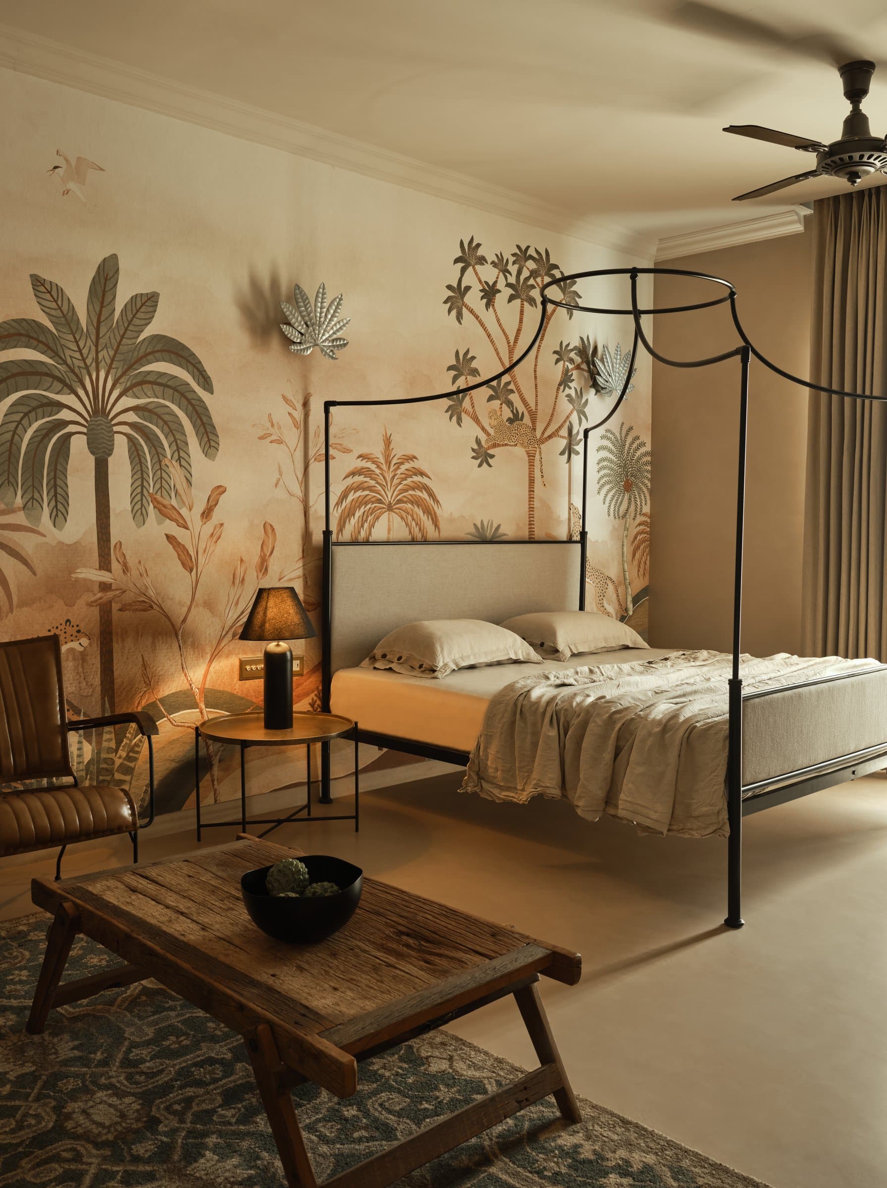 The guest bedroom, where a custom jungle wallpaper wraps the room in muted terracottas and greens