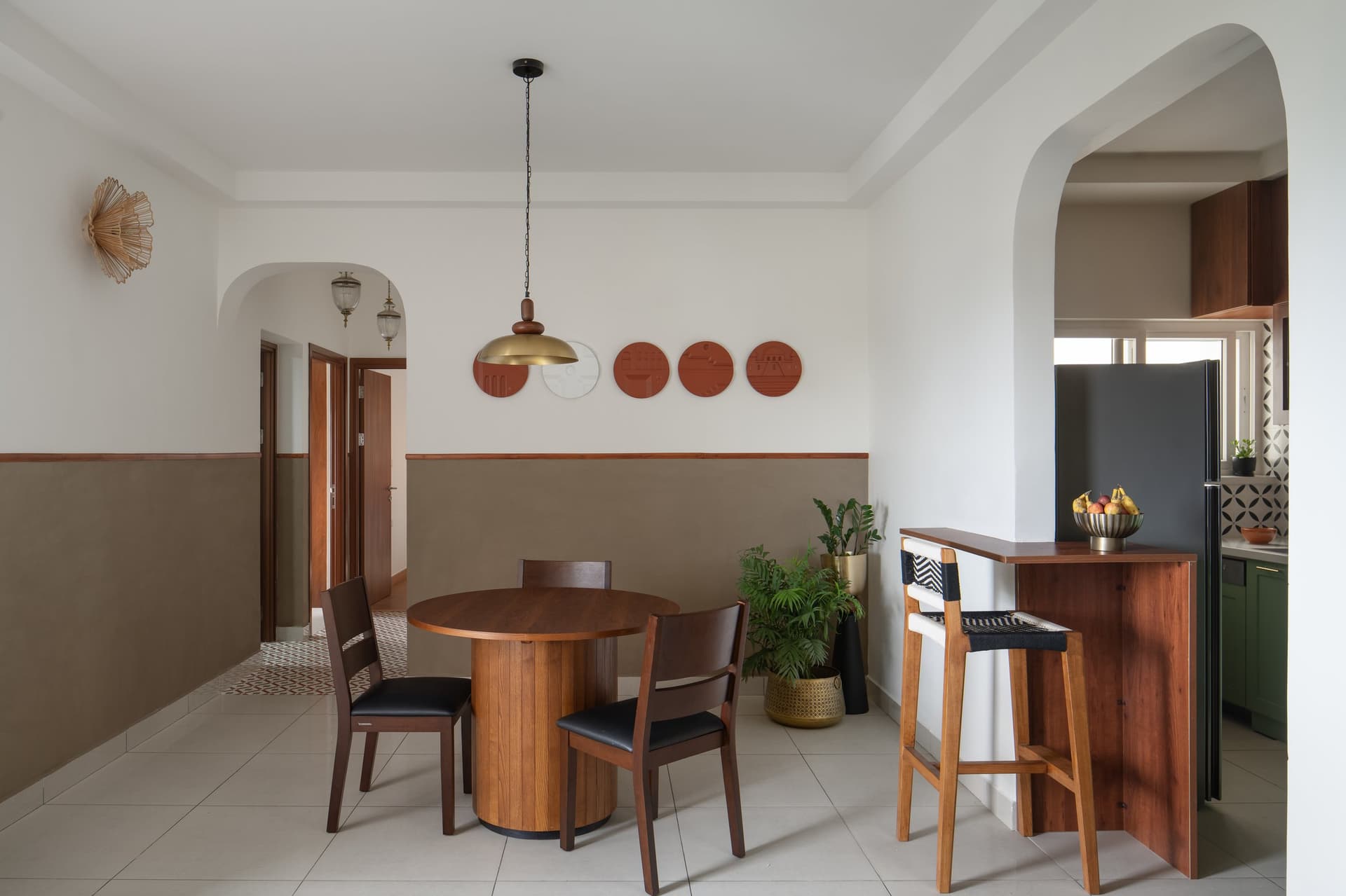 The dining wall, with its mud-finished limewash dado and a frieze of terracotta-toned relief plates