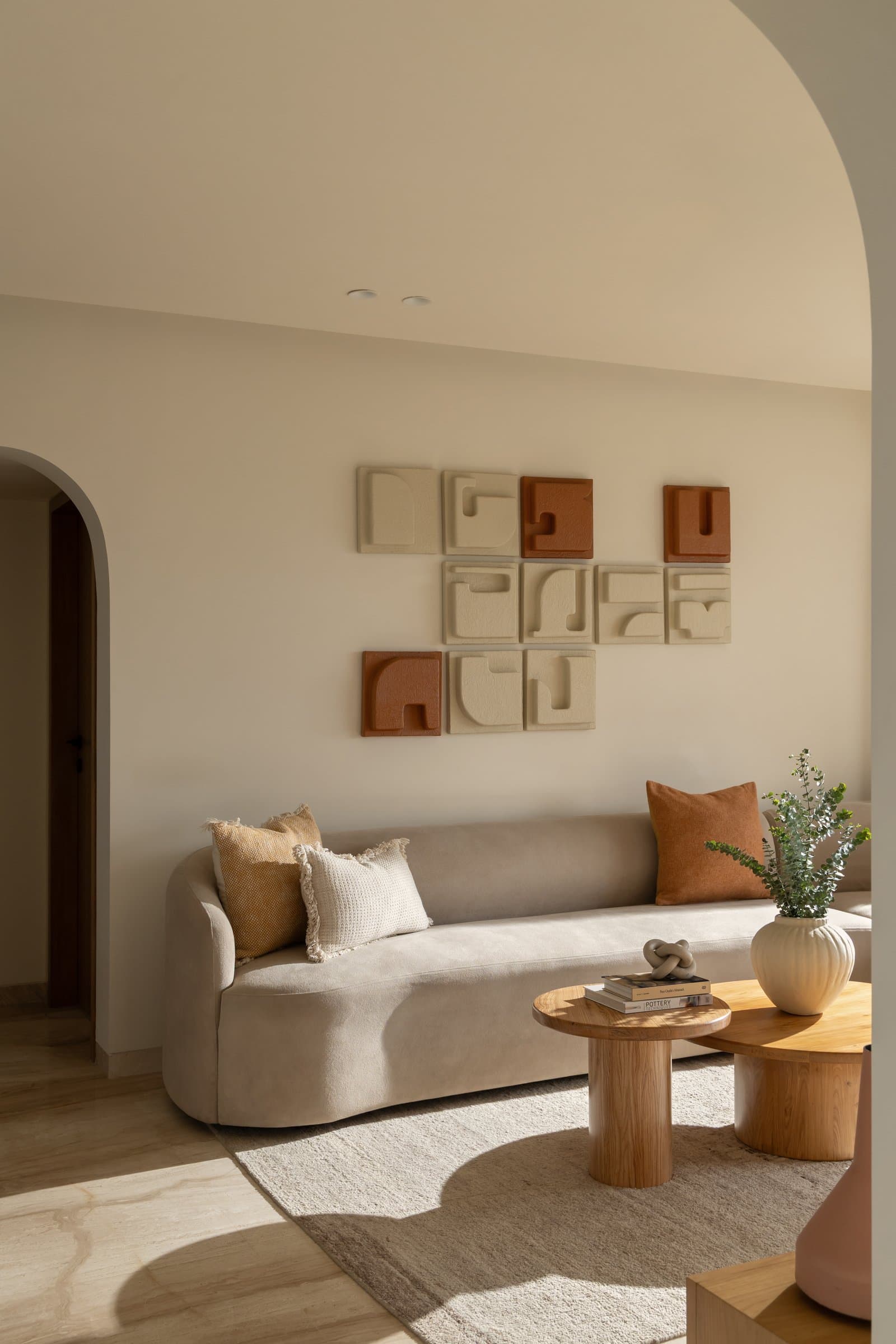 A commissioned grid of nine ceramic reliefs in ivory and rust, composed to be rearranged over time