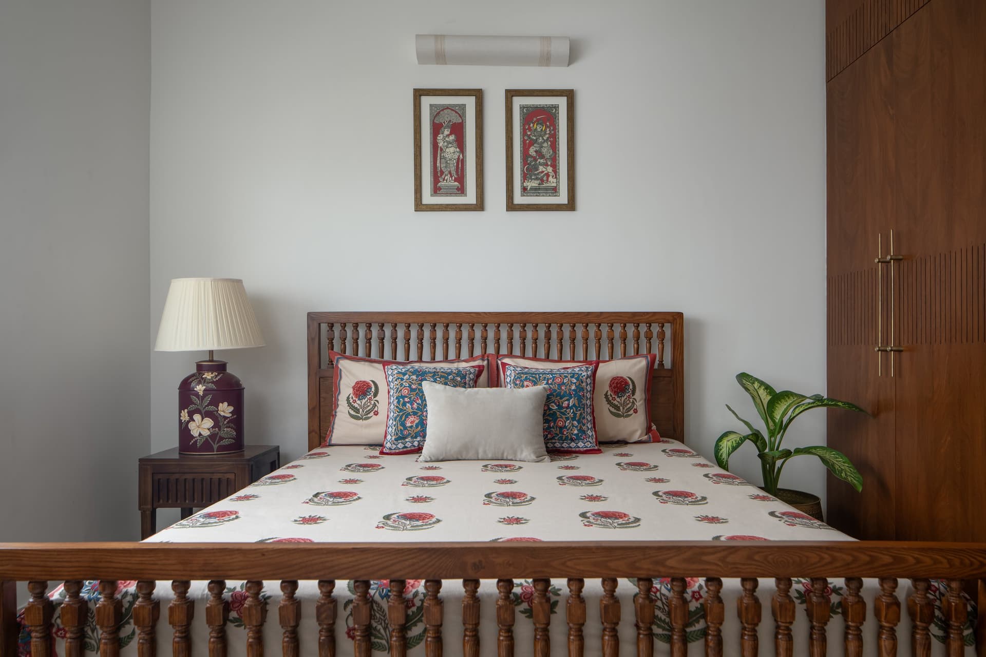 A second bedroom, where a spindle-backed bed and block-printed cushions extend the home's material language