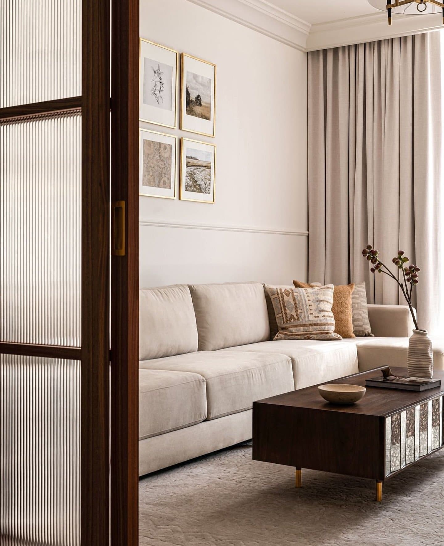A view through the reeded glass door into a second, quieter living zone.