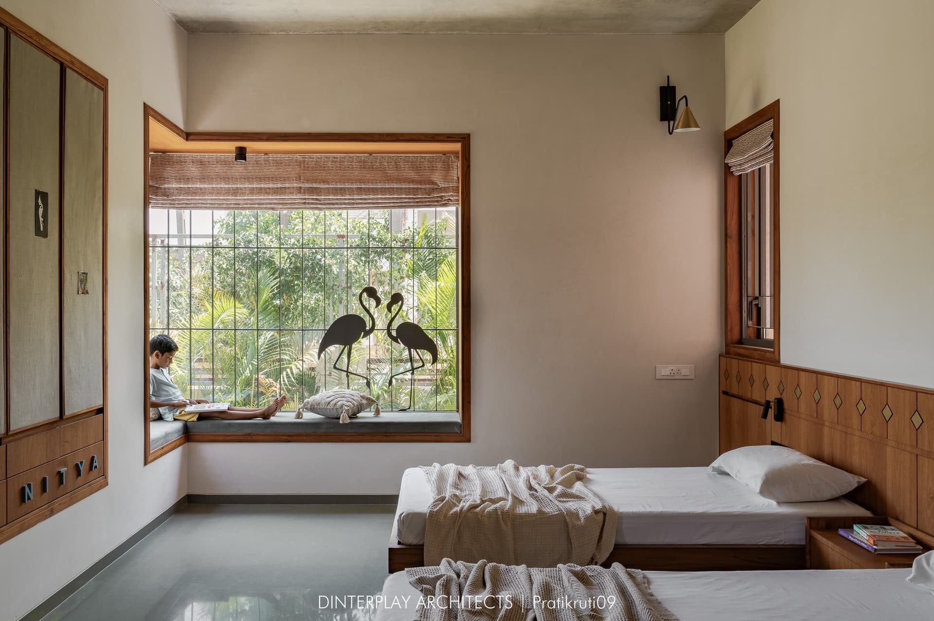 The children's bedroom, with a deep window seat, timber beds and inlaid wardrobe detailing