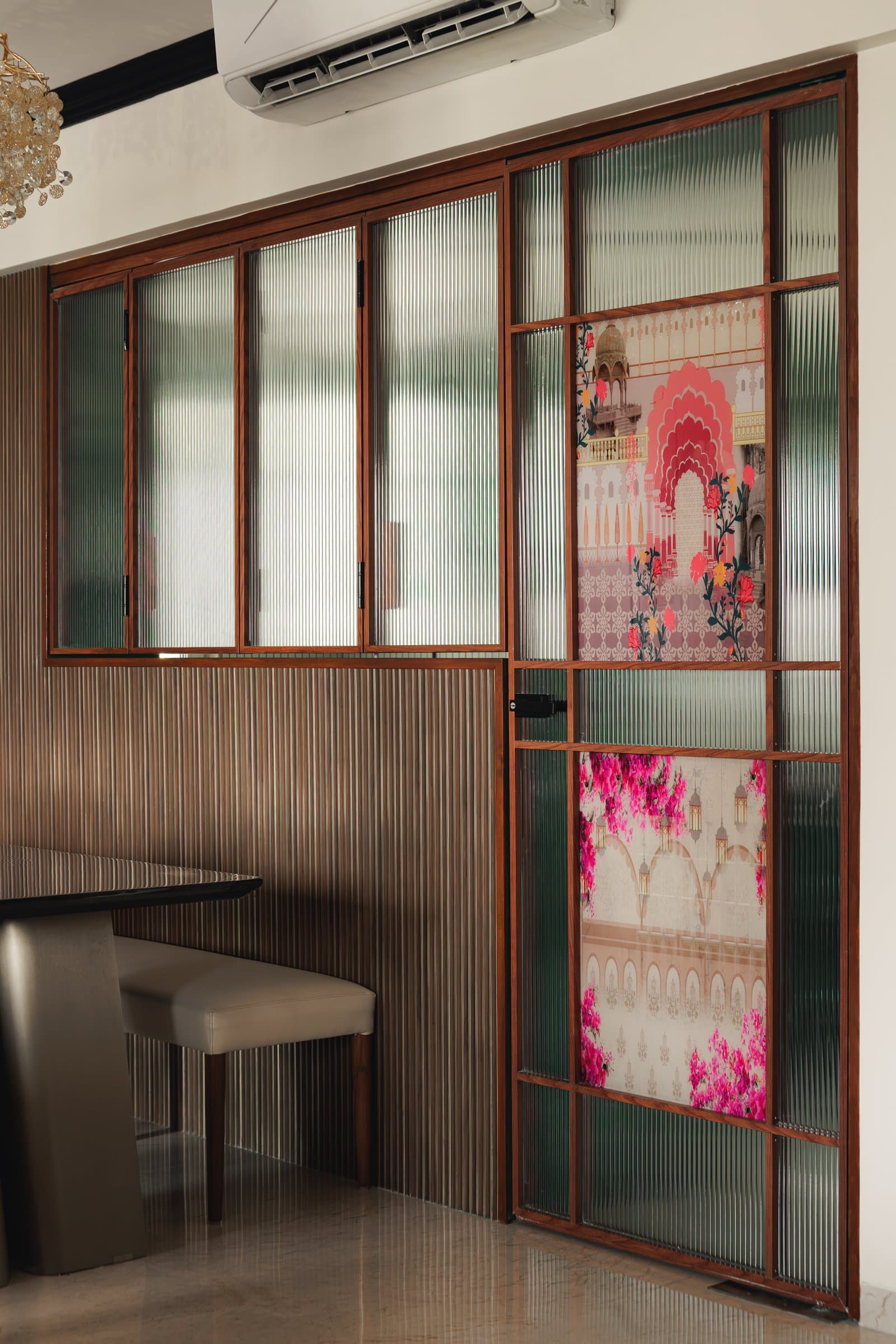 A second fluted glass panel with a printed architectural motif functions as both divider and composed ornament