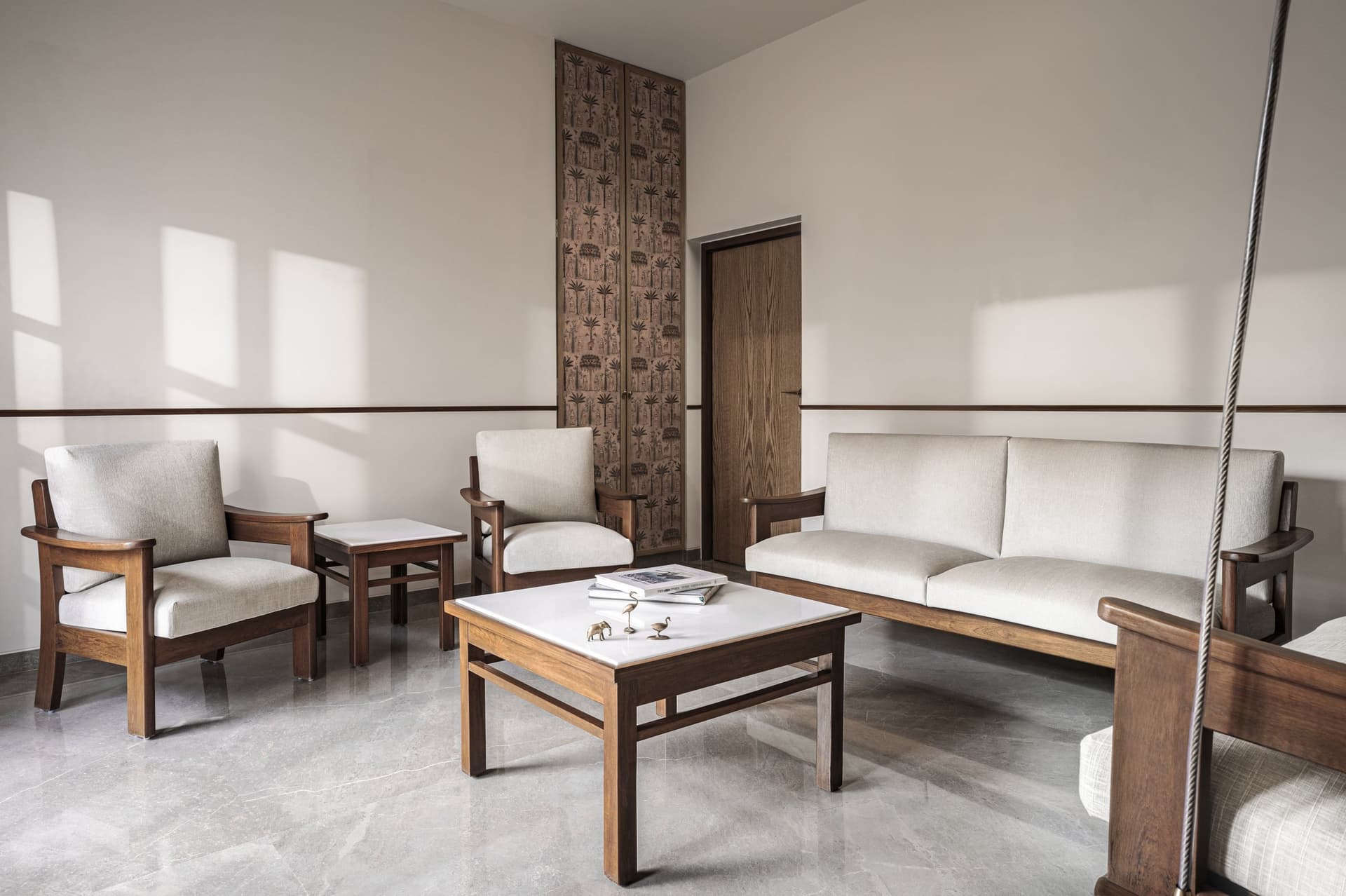 The drawing room, arranged around the family's refurbished seating and anchored by a tall patterned panel