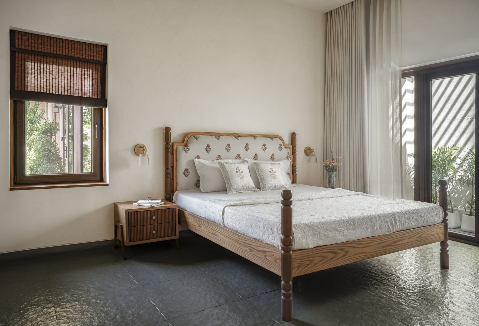 The primary bedroom, its bed built from timber repurposed from the original home