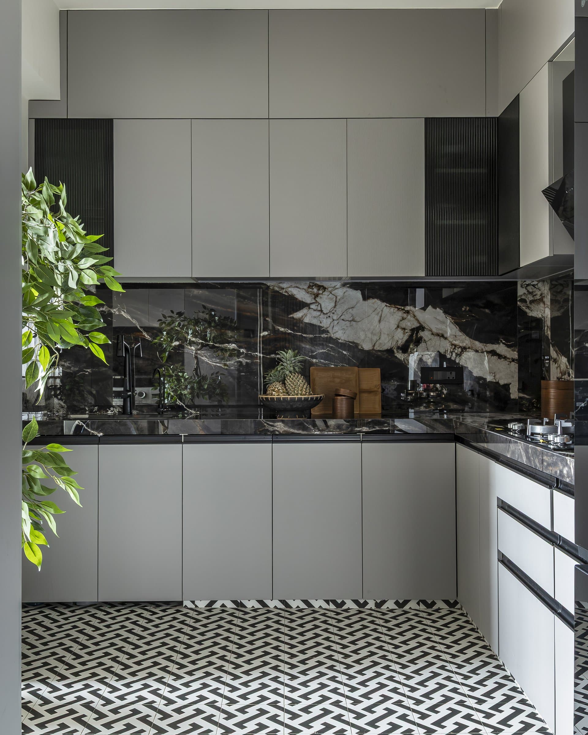 The kitchen's graphic ground, where a Moroccan-inspired interlocking floor tile anchors the room's bolder palette