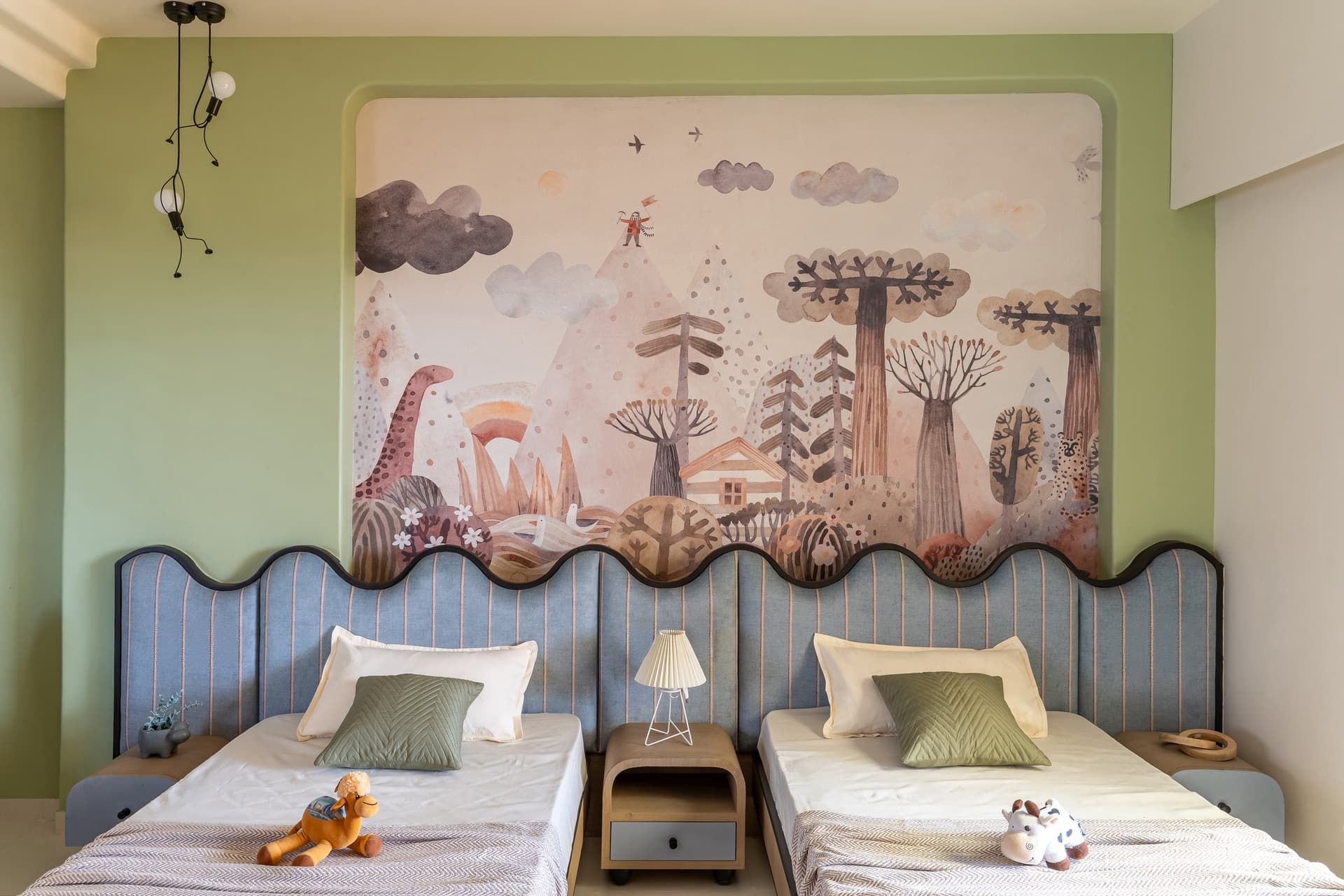 The children's bedroom, where wavy-edged headboards and a storybook wallpaper sit against a sage-green wall