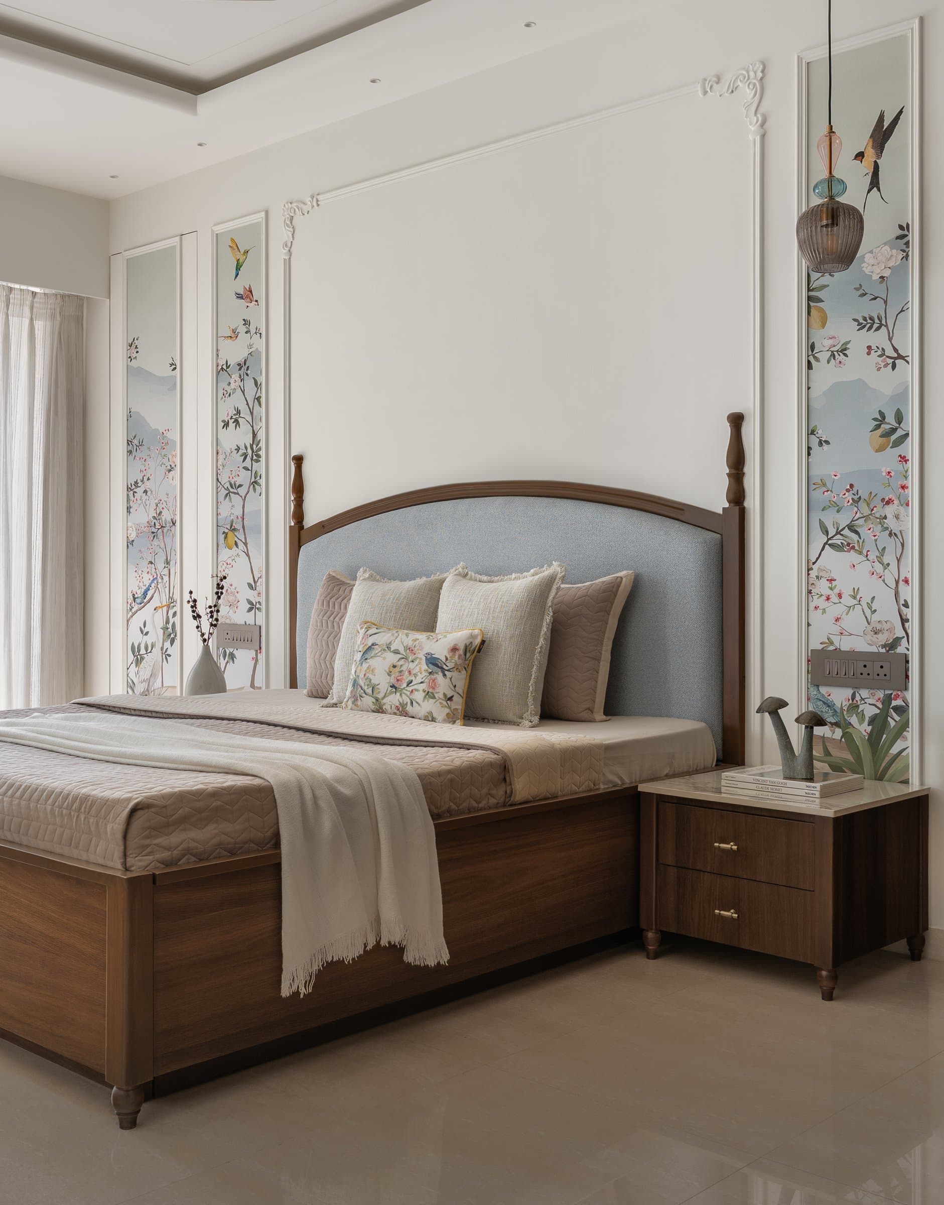 The master bedroom, with a classical turned-post bed, powder-blue headboard and botanical side panels
