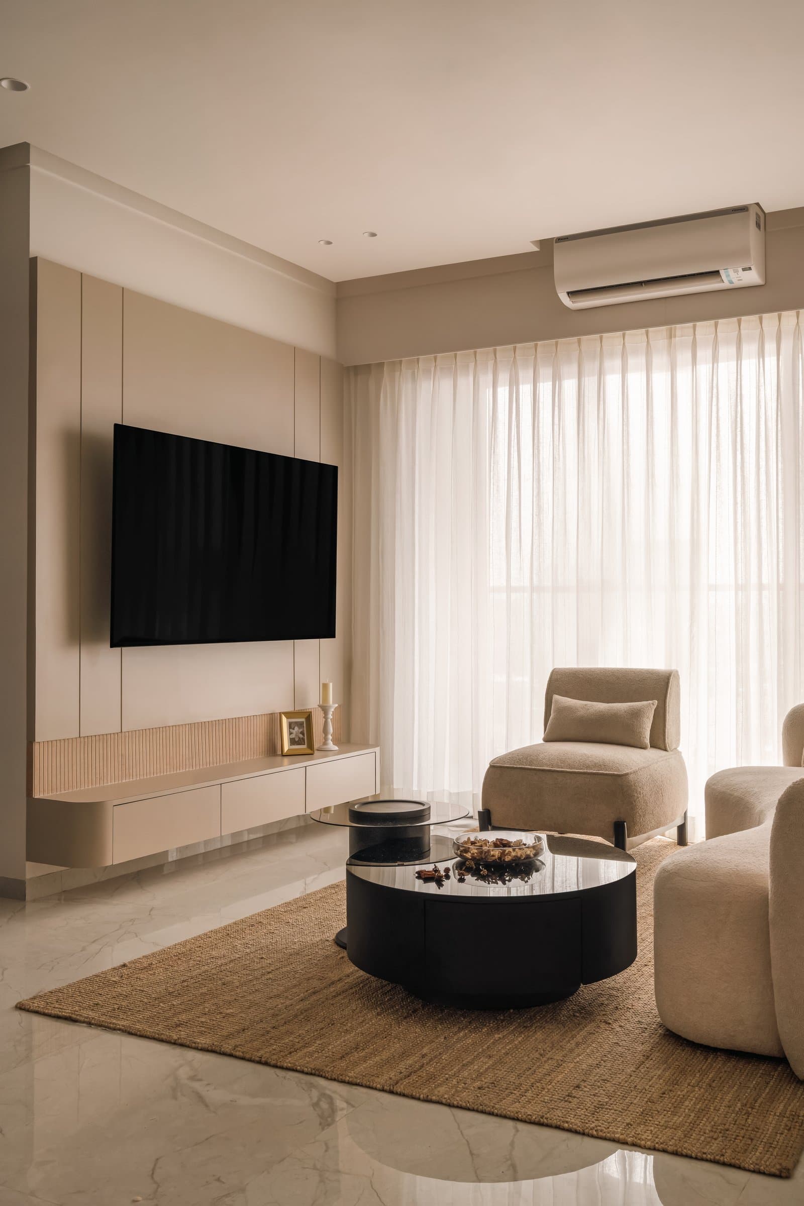 The living room, where a pale media wall and sheer drapery frame a composition shaped by filtered western light