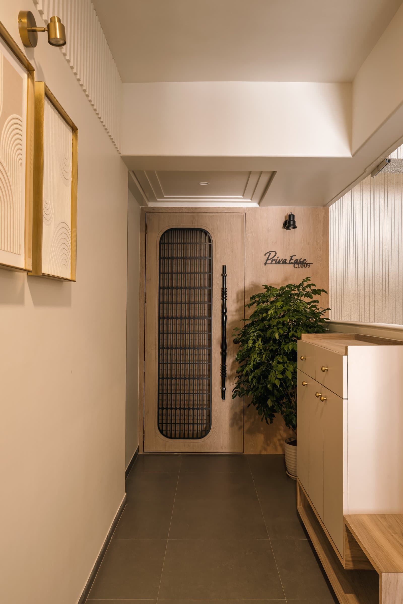 The entry foyer, where a wooden-framed door and a muted beige shoe cabinet set the home's restrained material language