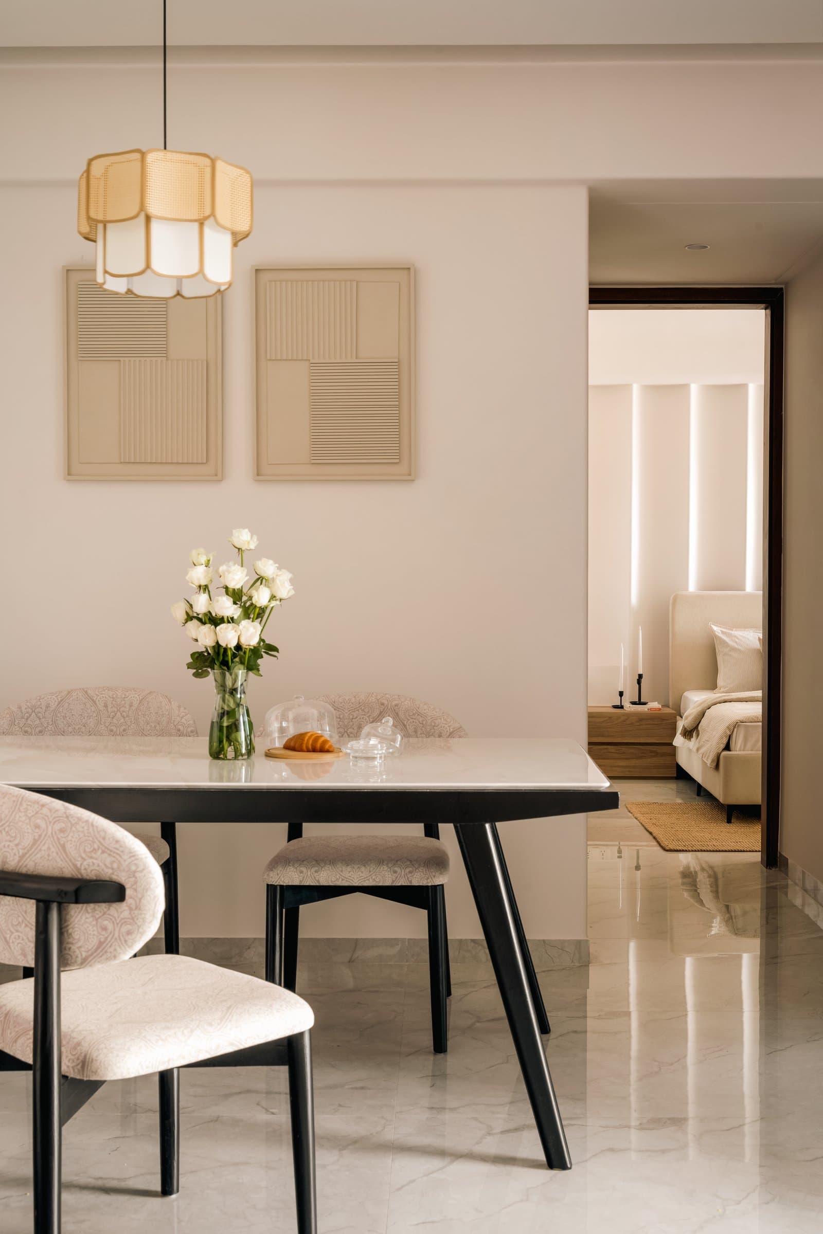 A sightline from the dining table opens through to the primary bedroom's wall of vertical light reveals