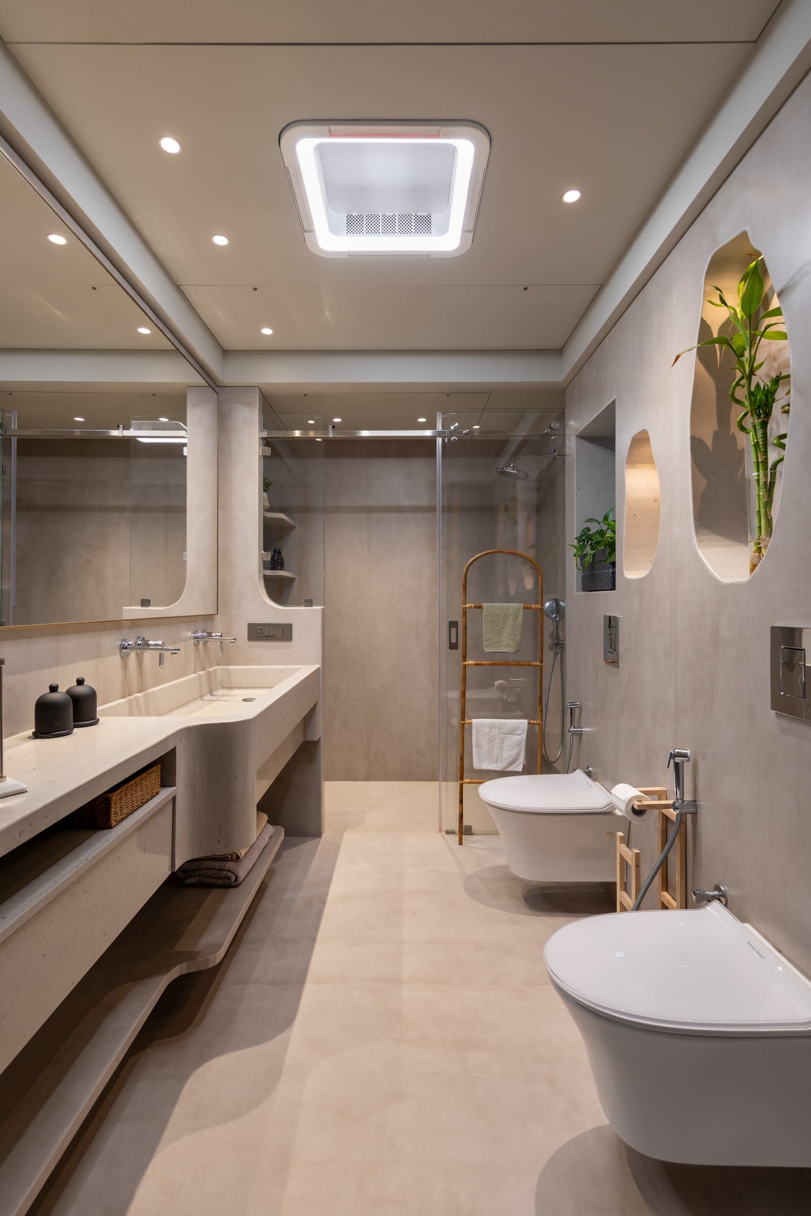 The primary bathroom, where a cast microcement vanity flows into an integrated basin with a sculptural curved edge