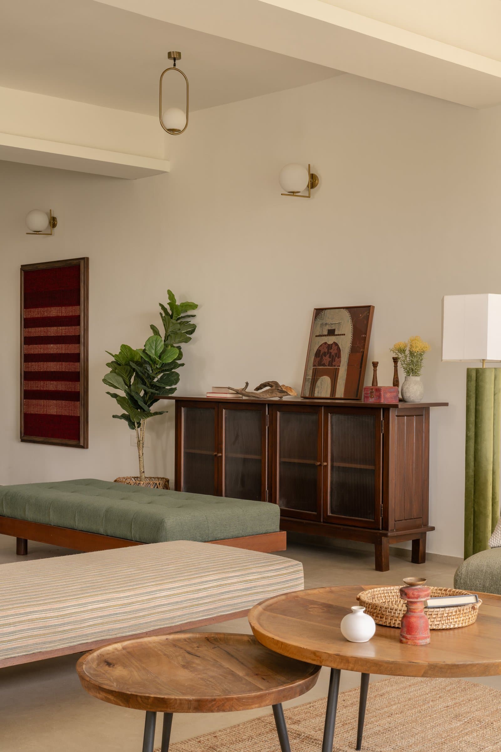 The sideboard wall, where reeded glass and a framed textile piece carry the collected sensibility of the room