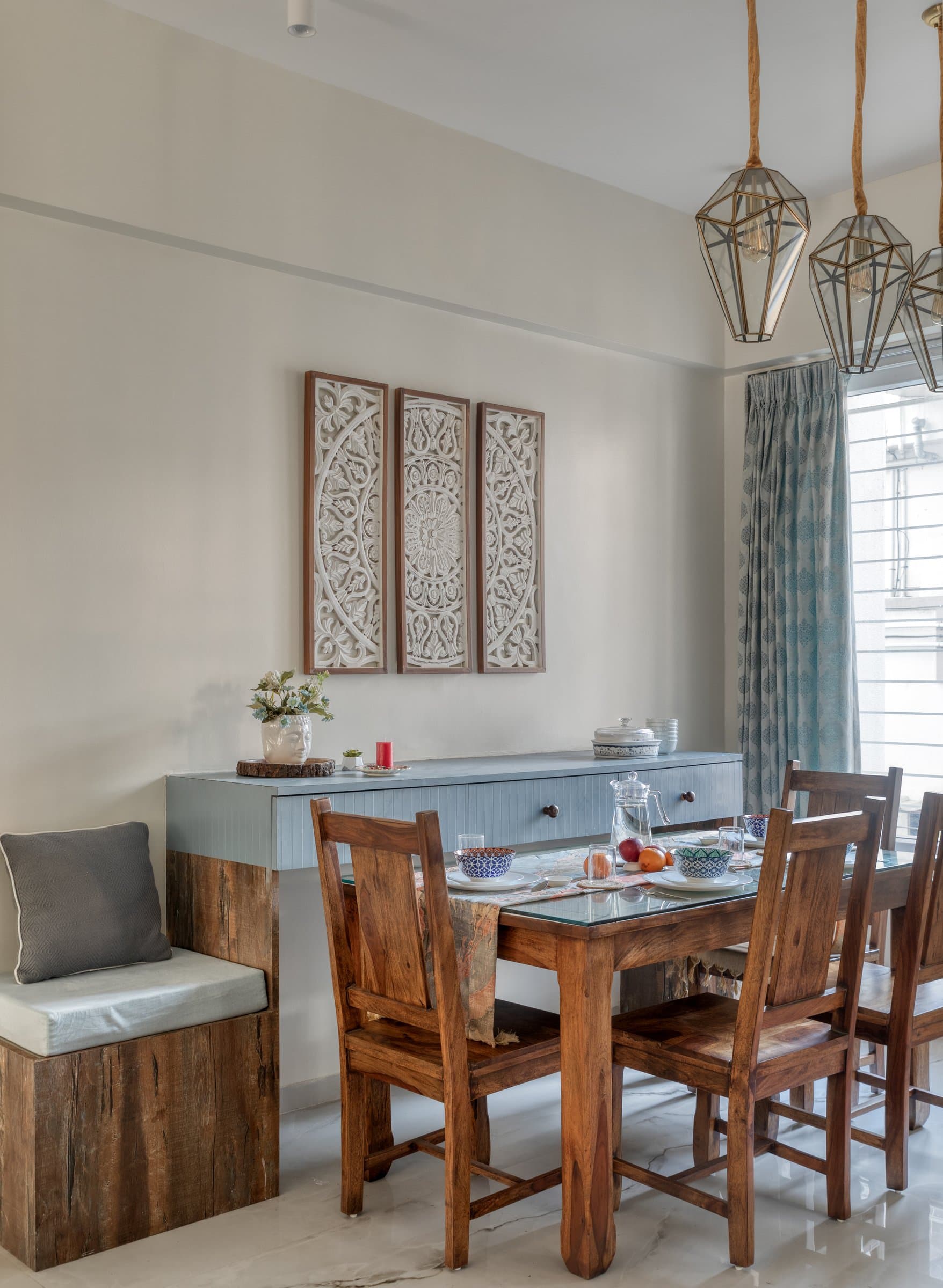 The dining table: solid sheesham, carved triptych panels, and a rustic bench seat that grounds the arrangement