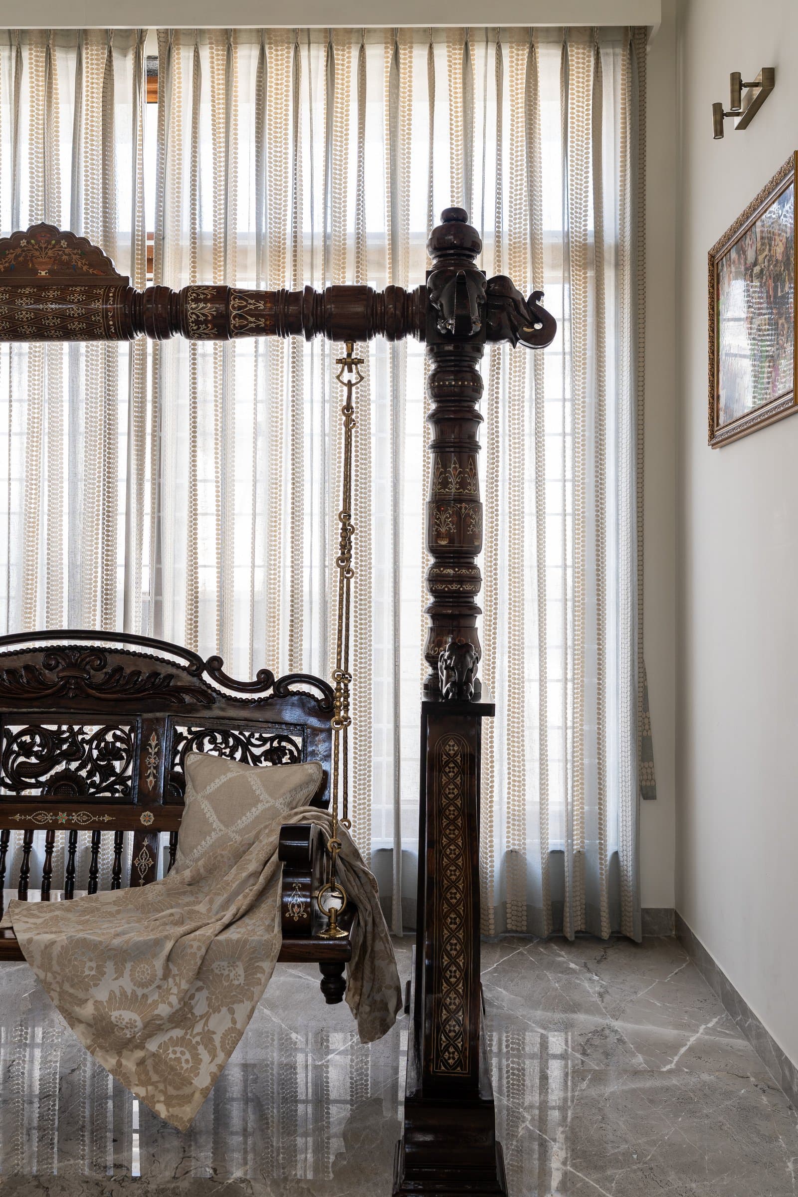 The ancestral swing in carved teak with bone inlay, the home's oldest object and its emotional centre