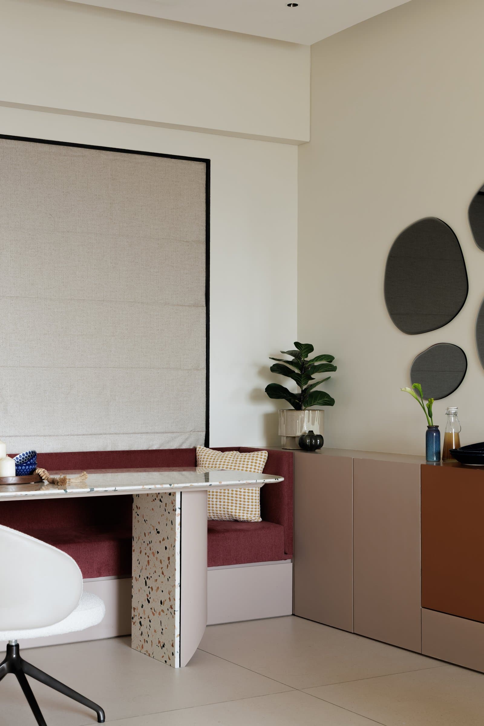 The credenza's graduated panels in rose, mauve, and burnt orange read almost as colour-blocked art