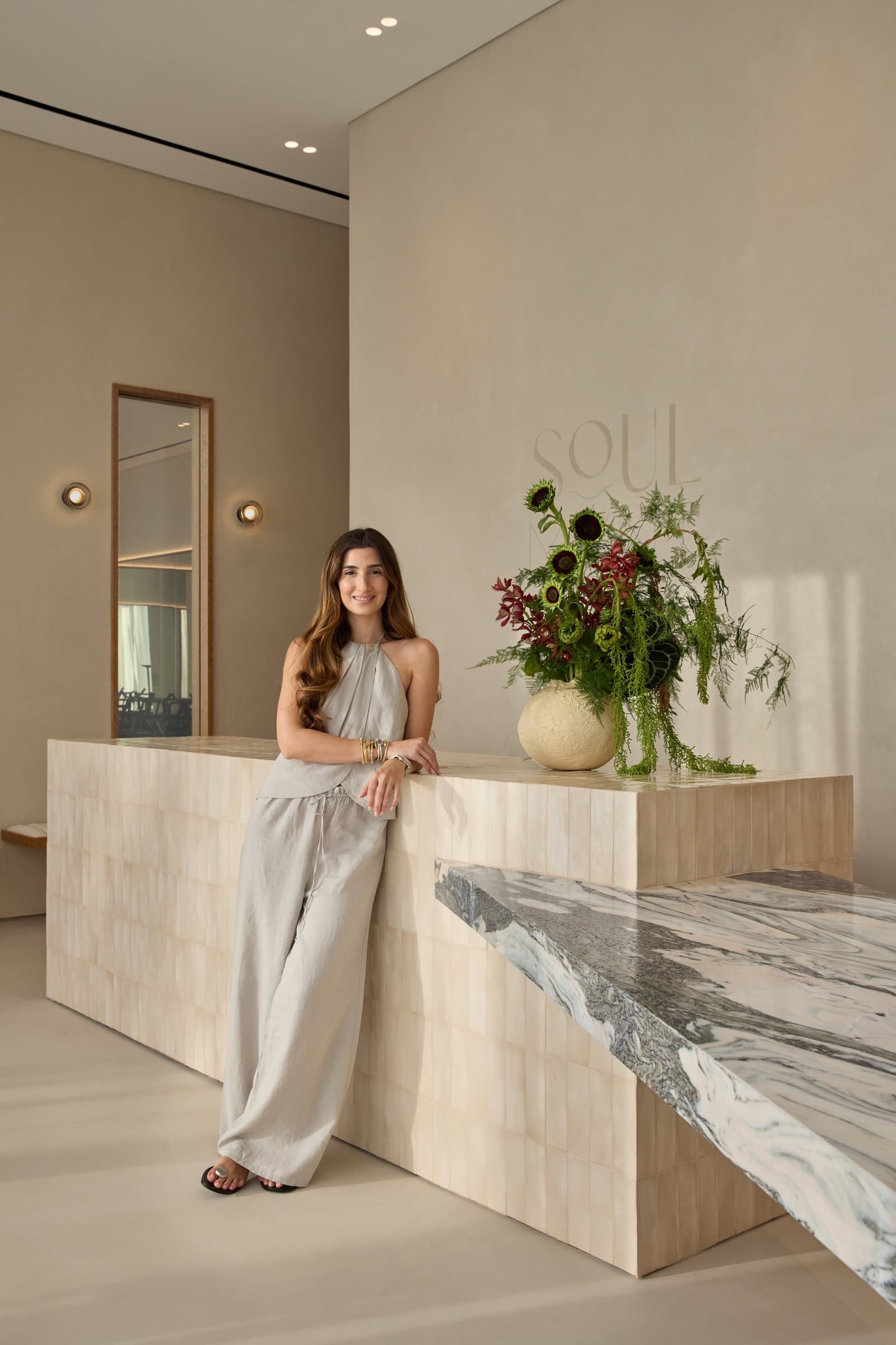 The reception desk in handmade ivory tiles, with an Avalanche marble shelf cantilevered to one side