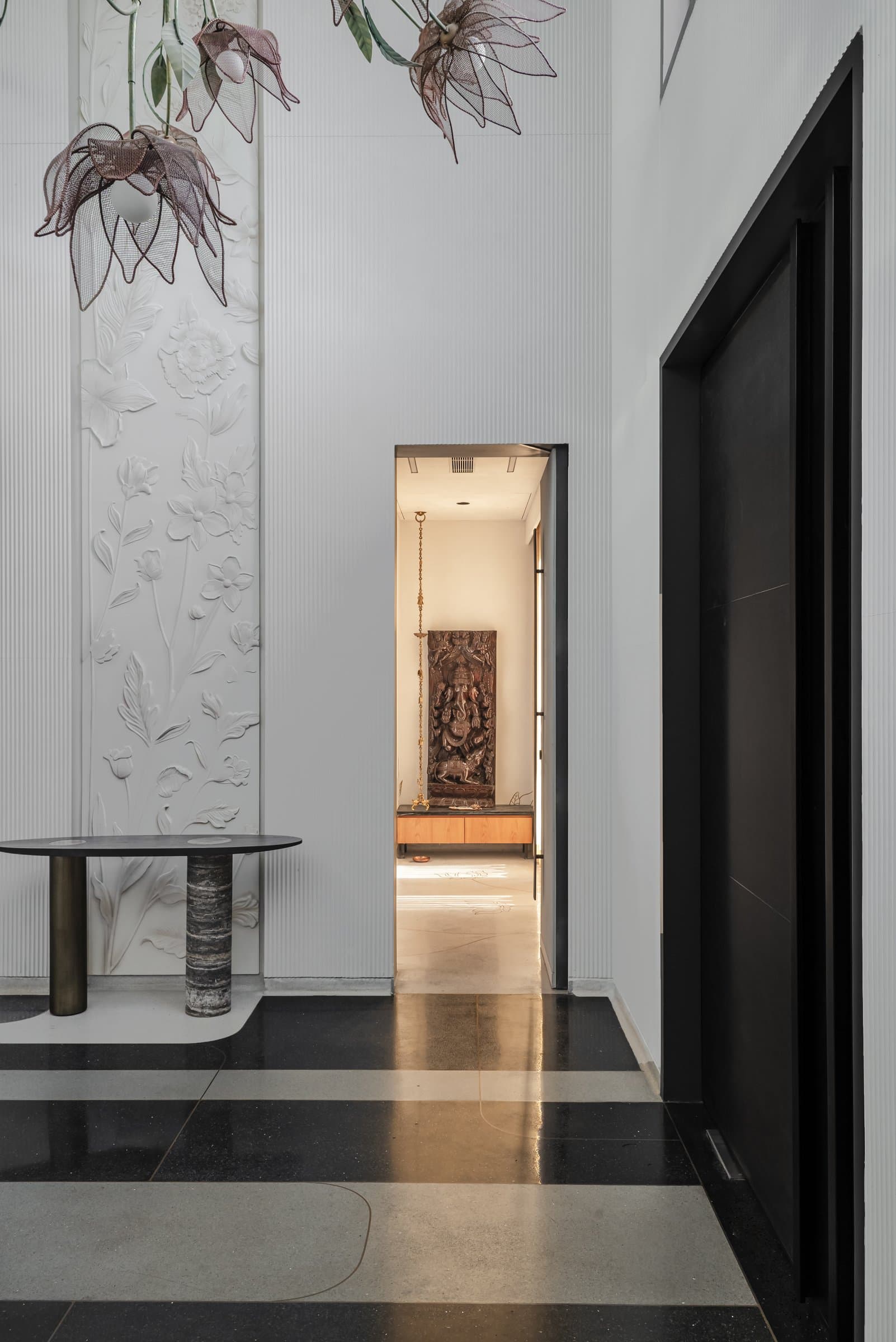 Looking back from the inner corridor: lotus-shaped pendants hover above an oval console