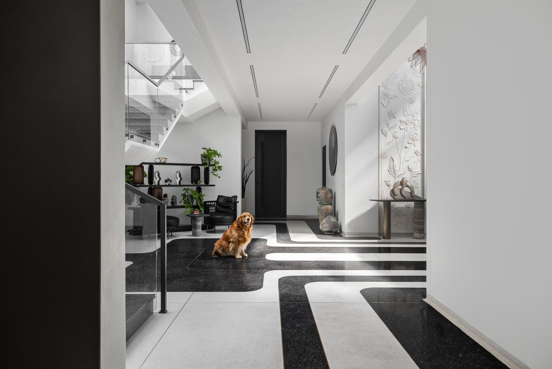 Looking into the foyer from the entry: the curving stone inlay choreographs the path forward