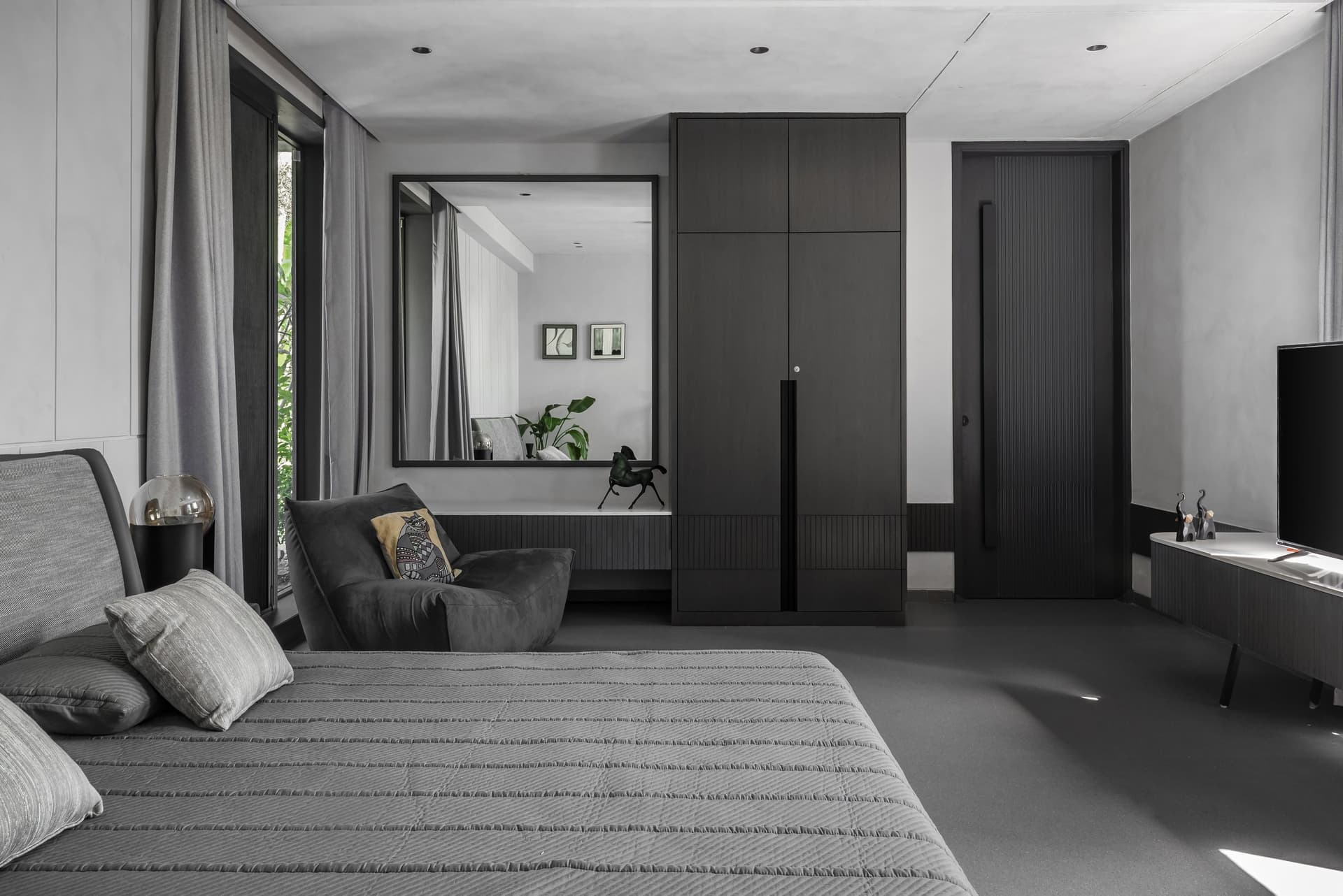 The master bedroom takes the palette into quieter, deeper territory