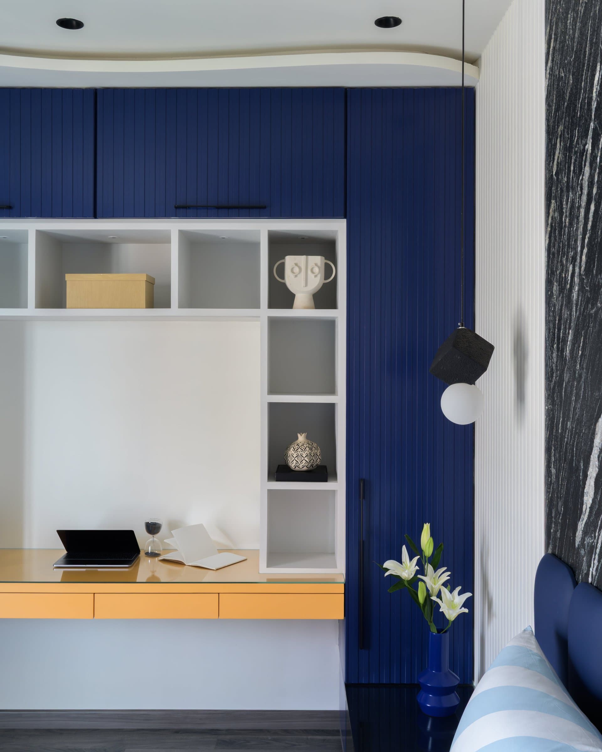 The study nook, where blue joinery meets a mustard-toned desk surface
