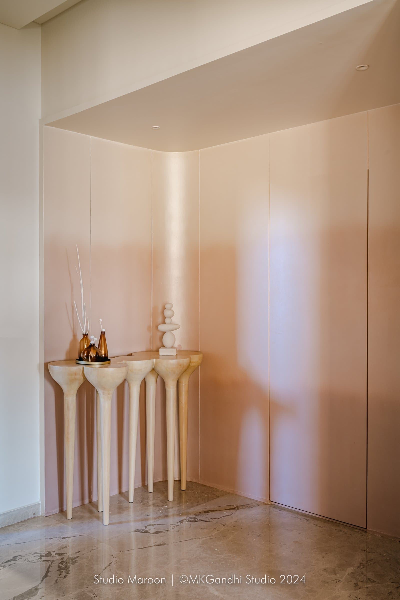 The vestibule, where a sculptural console on elongated turned legs sets the tone for form-led detailing