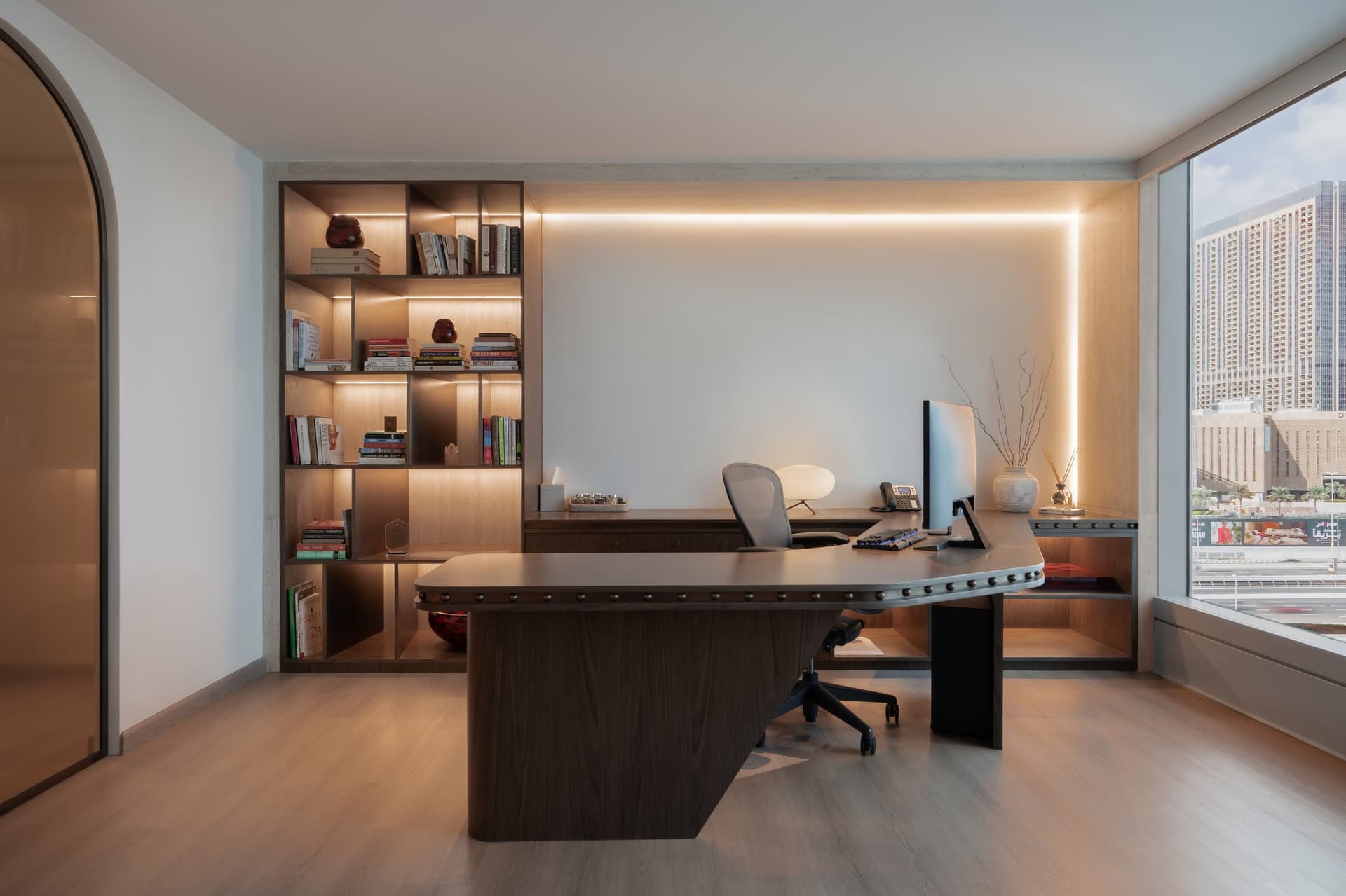 The principal cabin, where a walnut desk with a studded edge sits before a backlit built-in library