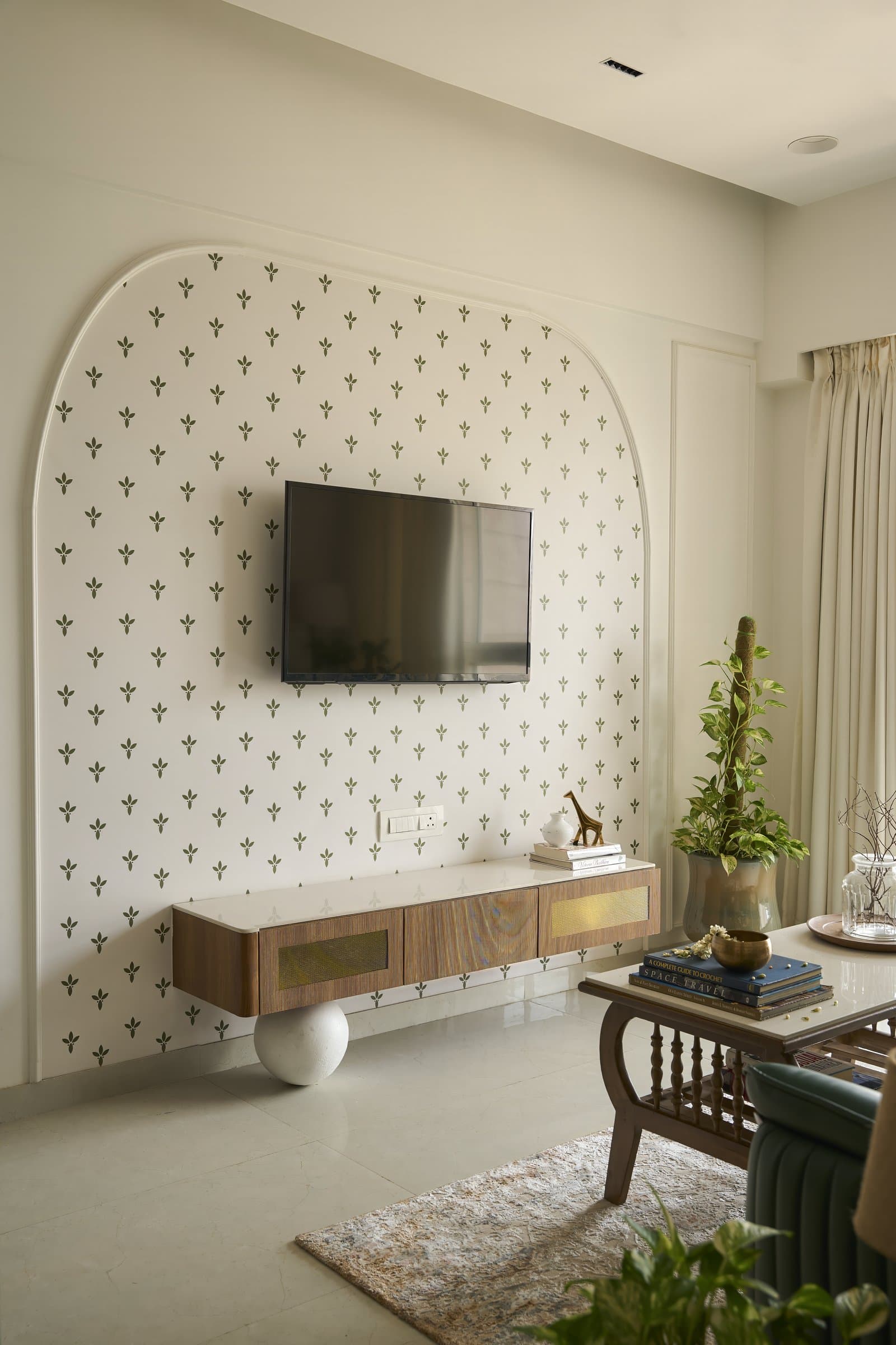 The media wall, where an arched stencilled panel frames the television as if it were a piece of art within a proscenium