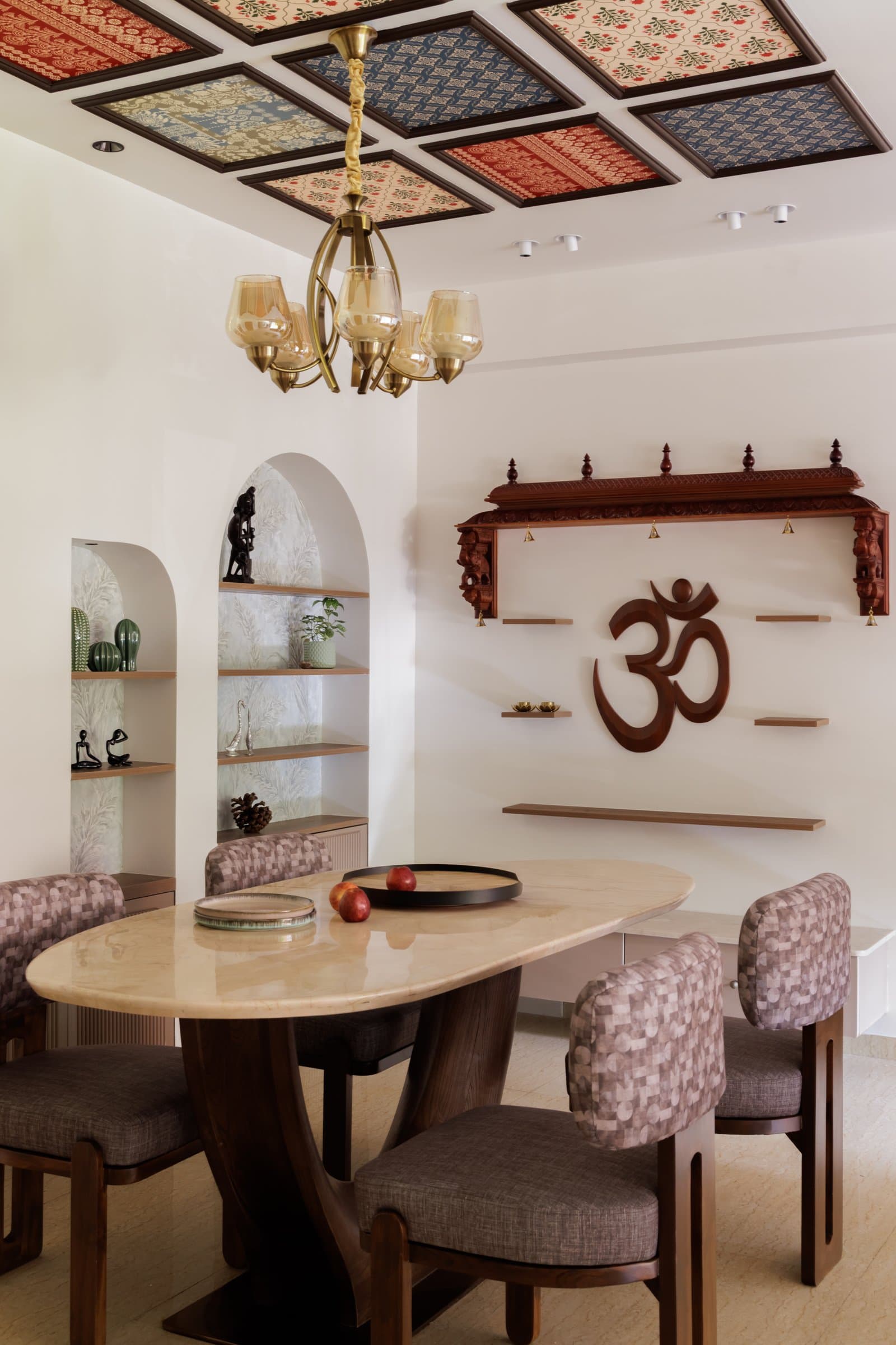 The dining area, where a coffered ceiling of framed textile panels holds the home's boldest cultural gesture overhead