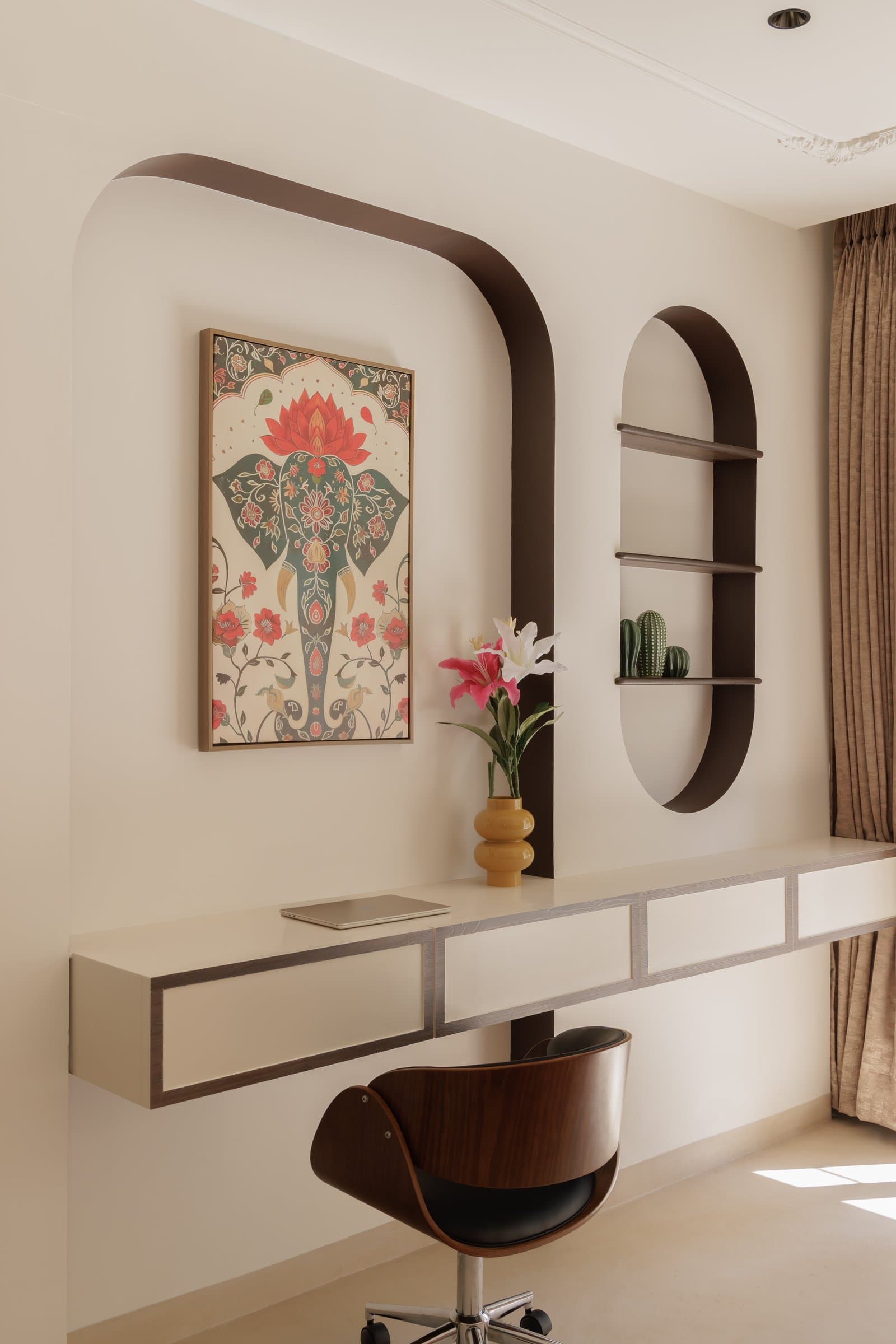 The study niche, where a folk-inspired artwork of an elephant and lotus sits within a softly arched wall composition