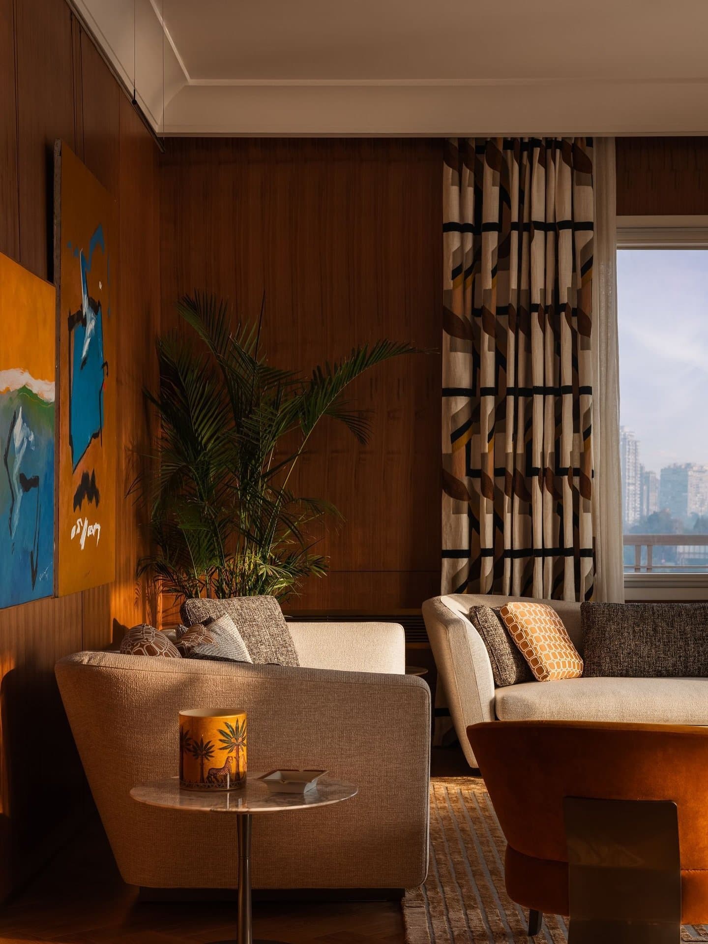 A quieter corner of the living room, where wood panelling holds the last of the afternoon light.