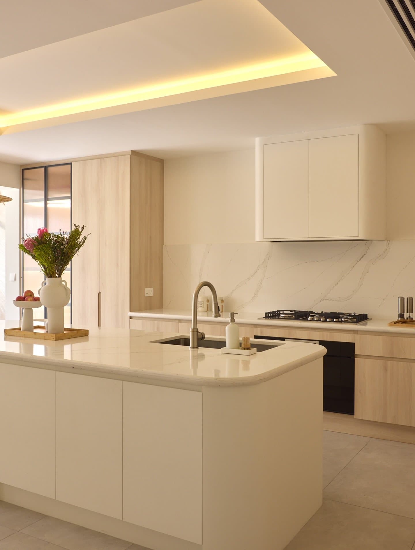 The kitchen's curved island anchors the reworked social core.
