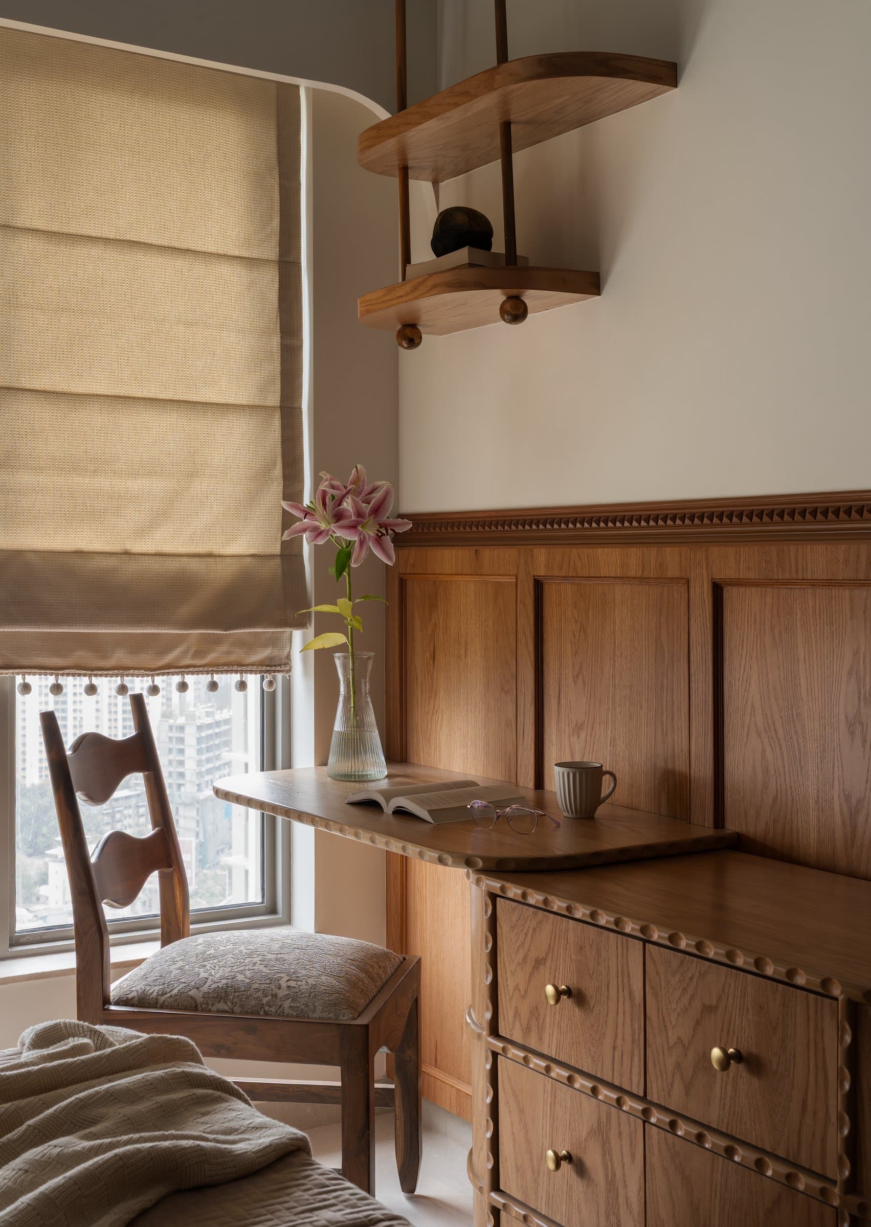 The study nook, where a wooden writing surface edged in beaded moulding extends from panelled cabinetry