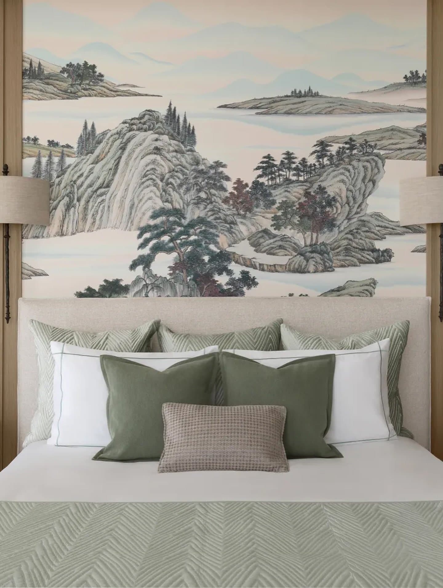 Fromental's mountain-and-water landscape wallpaper draws the second bedroom into a cool, cocoon-like calm.