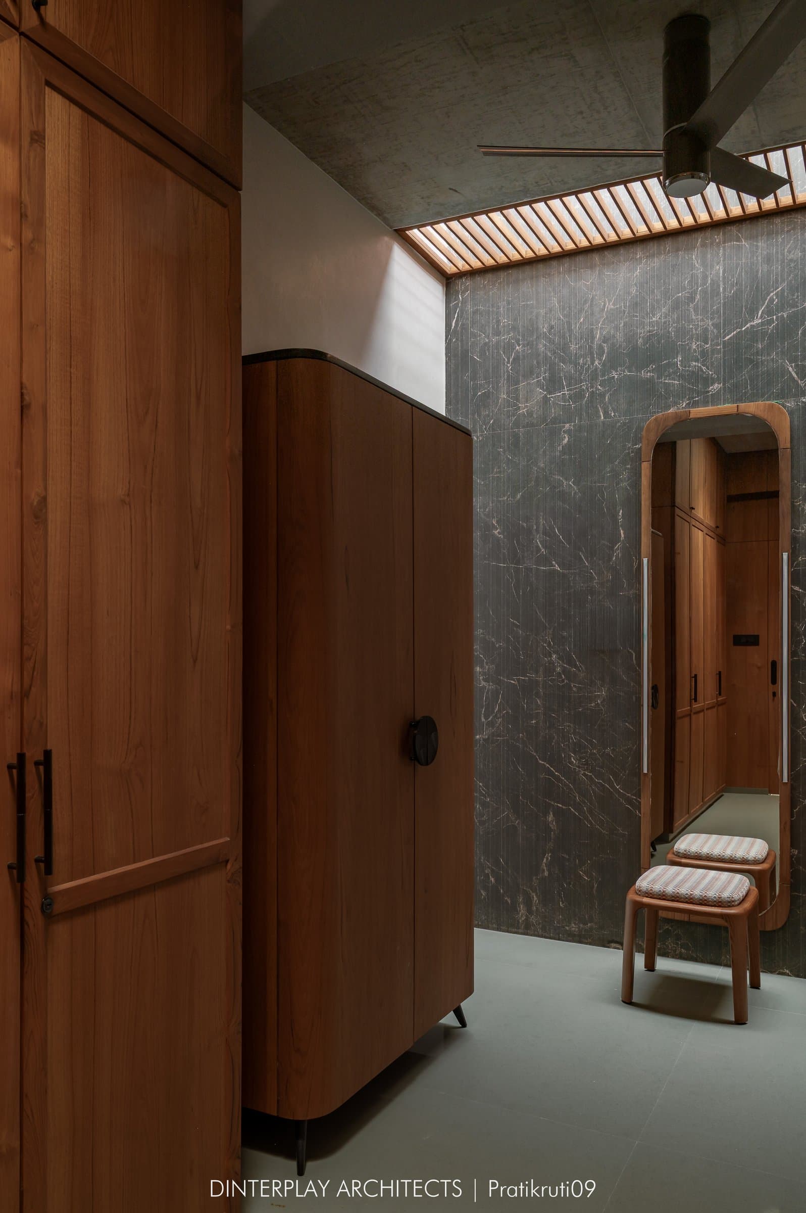 The adjoining dressing area, a study in tonal restraint between warm timber and veined marble