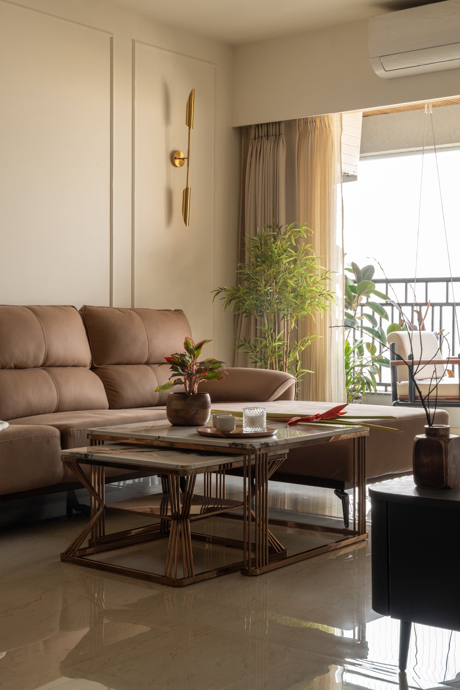 A closer view of the seating: leather, marble-topped nesting tables and greenery drawn in from the balcony
