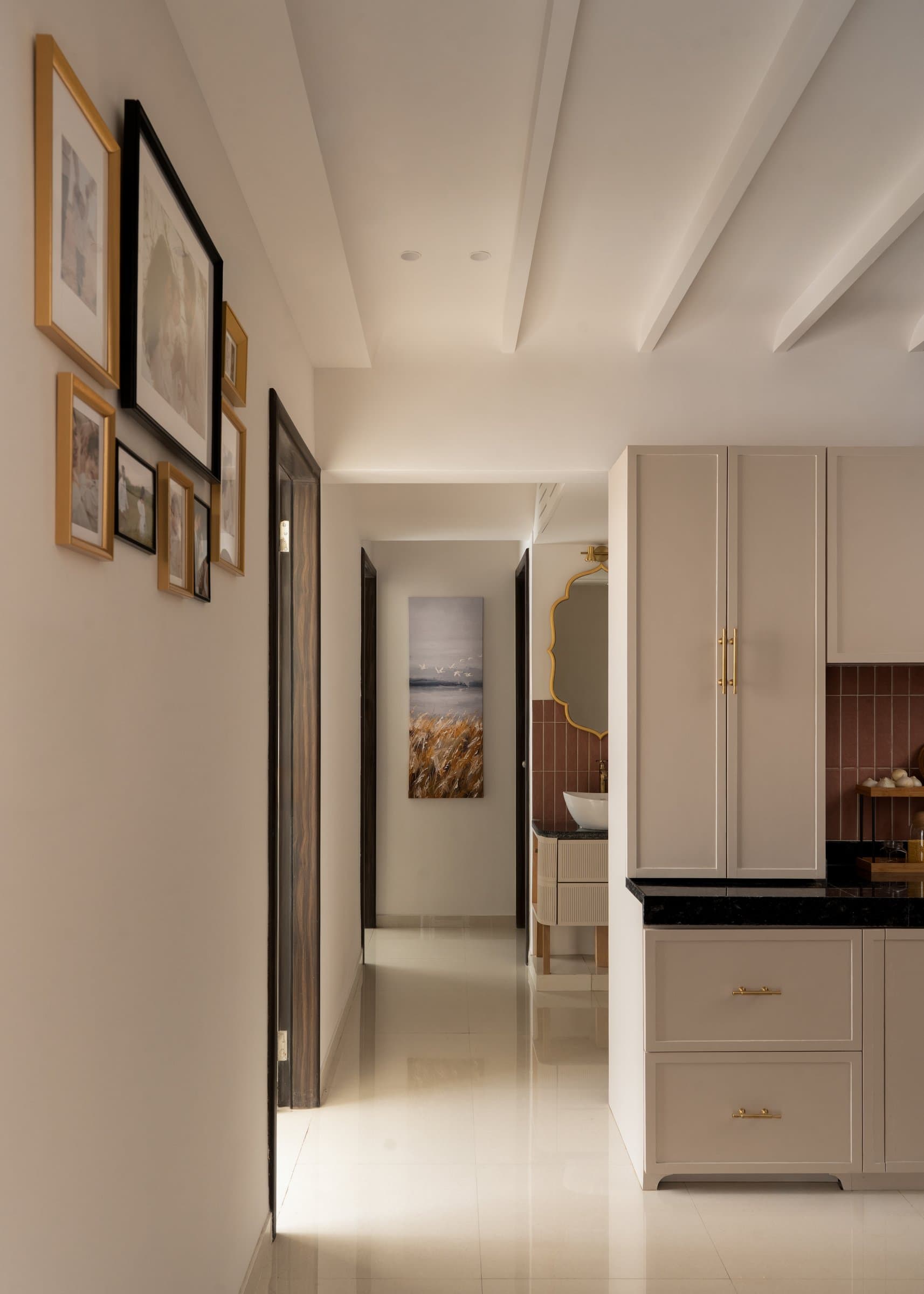 The circulation corridor, its gallery of framed prints and fluted ceiling tying the plan together