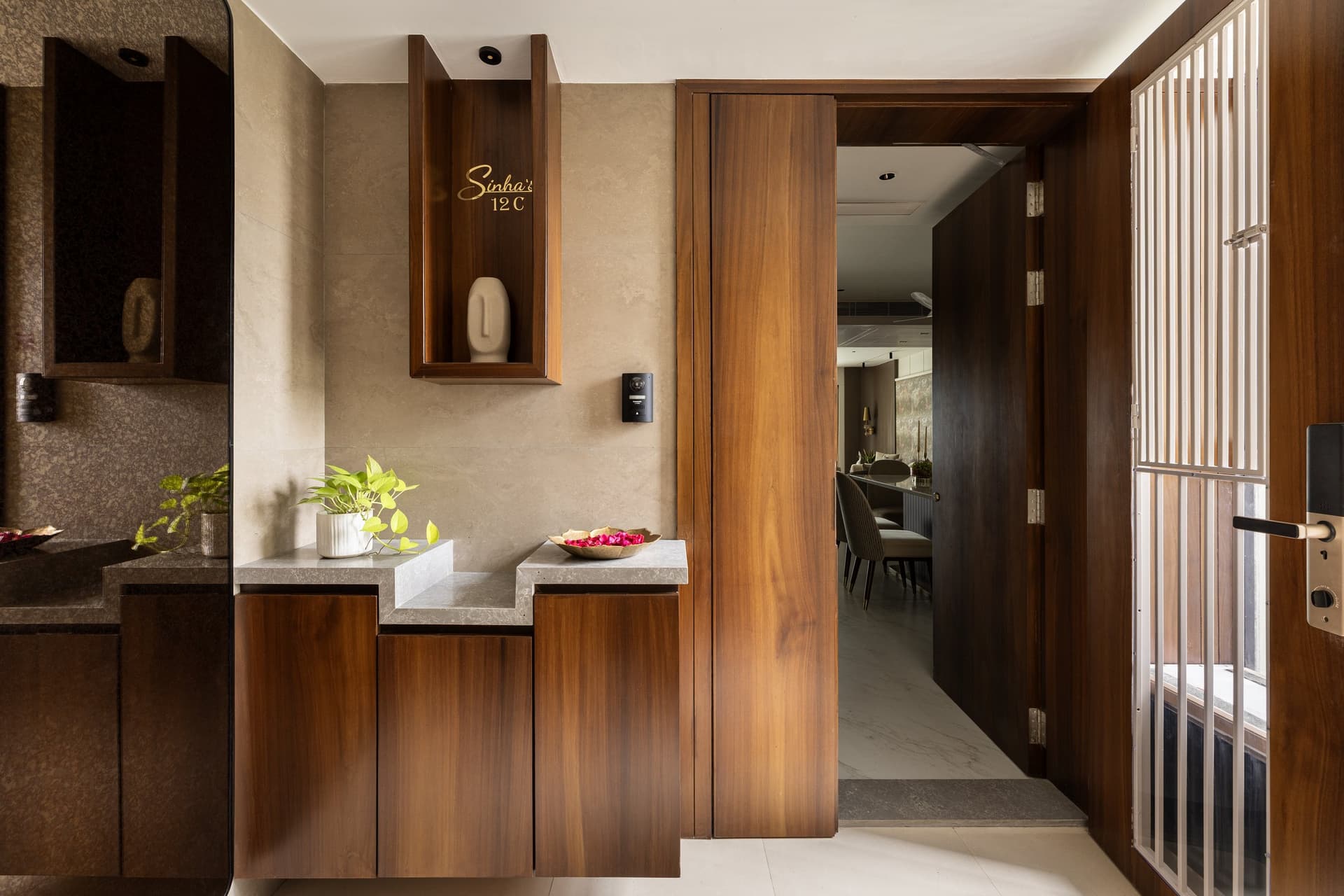 The entry vestibule, where a stone-topped console and a slender niche marked Sinha's 12C set a quiet, personal tone