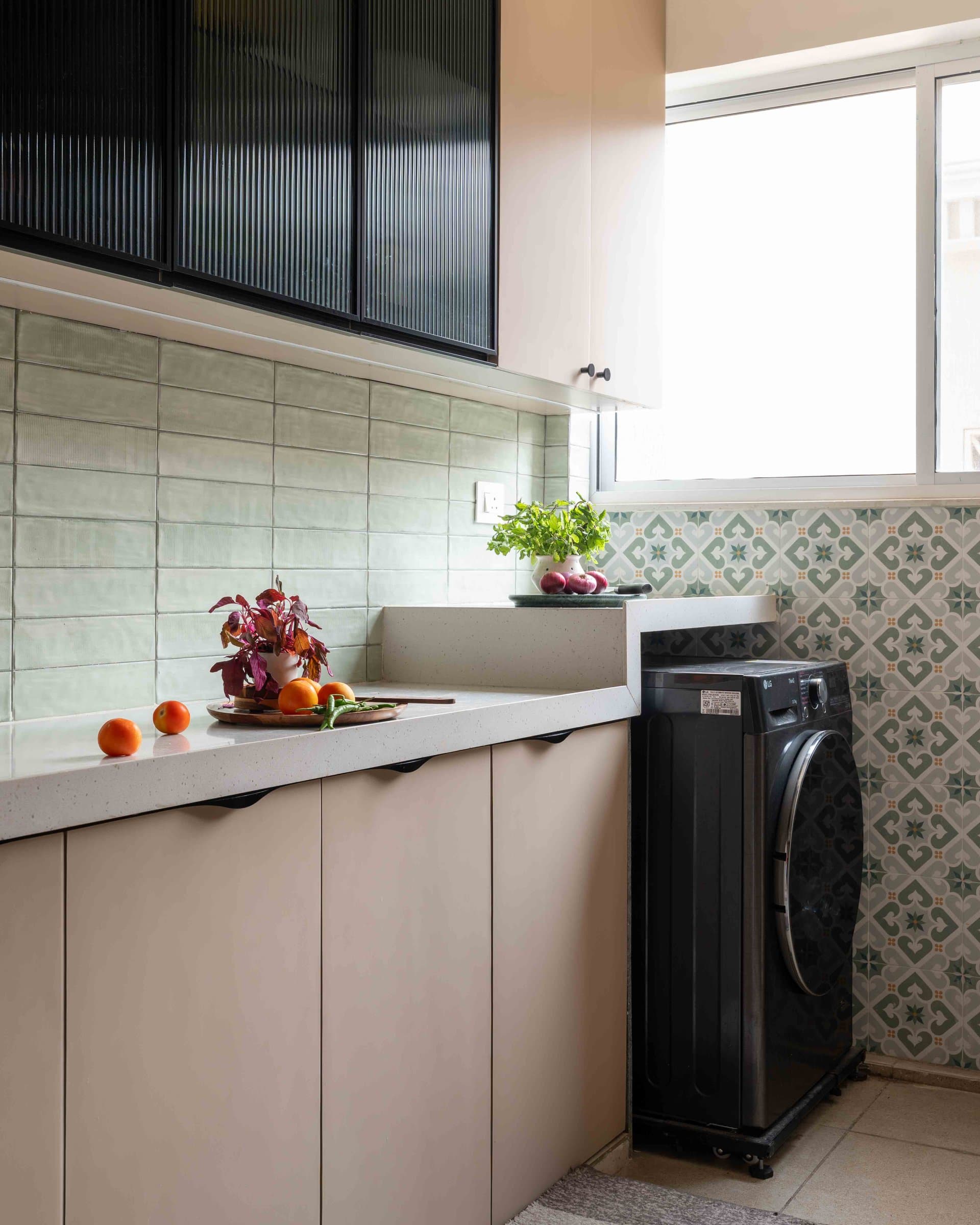The utility, where a patterned encaustic tile in muted greens meets the plainer field tile of the kitchen