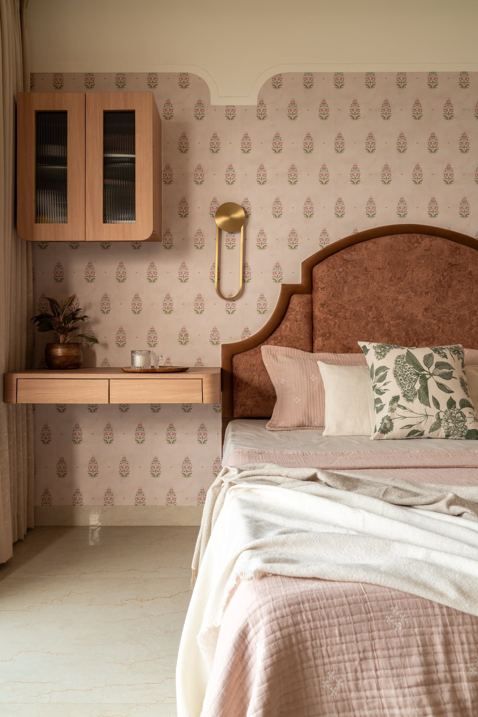 A quieter view of the master, the wall-hung cabinet and floating desk in warm wood recessive against the pattern