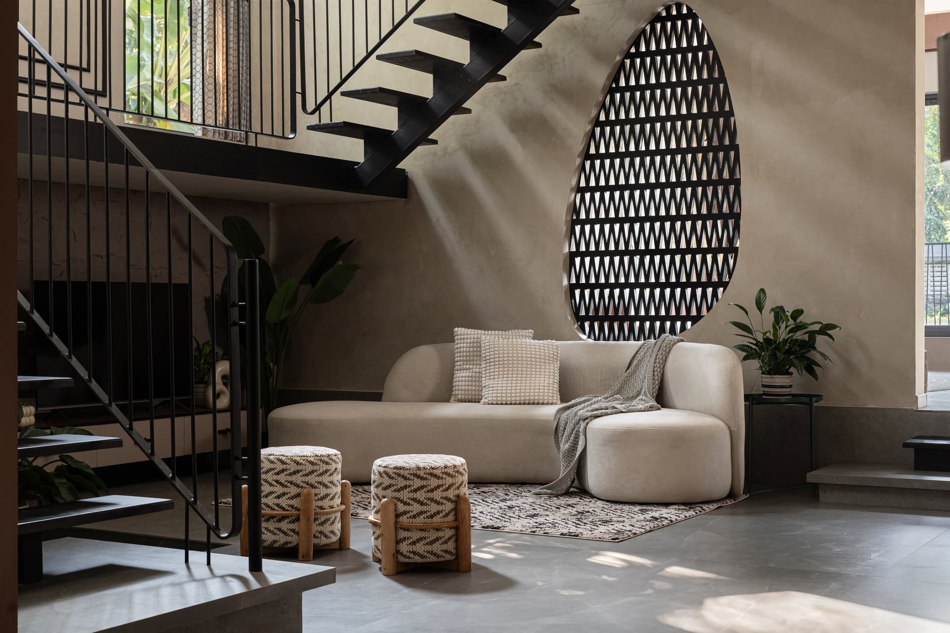 The family living area, organised around the open-tread staircase and an ovoid lattice screen