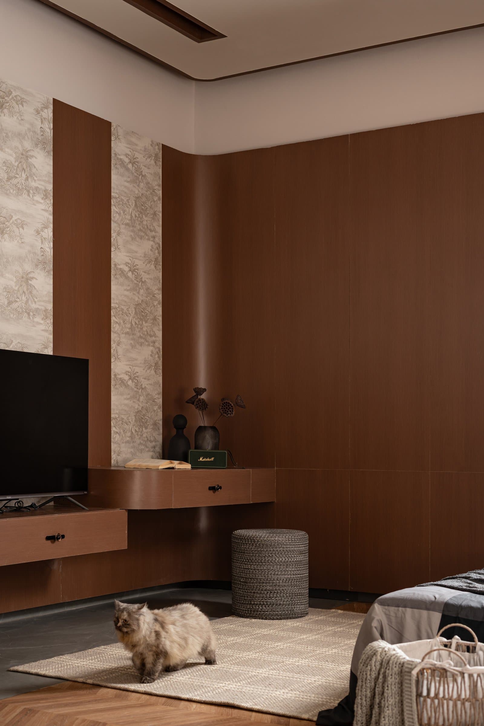 The second bedroom's media wall, handled as warm wooden joinery first and equipment second