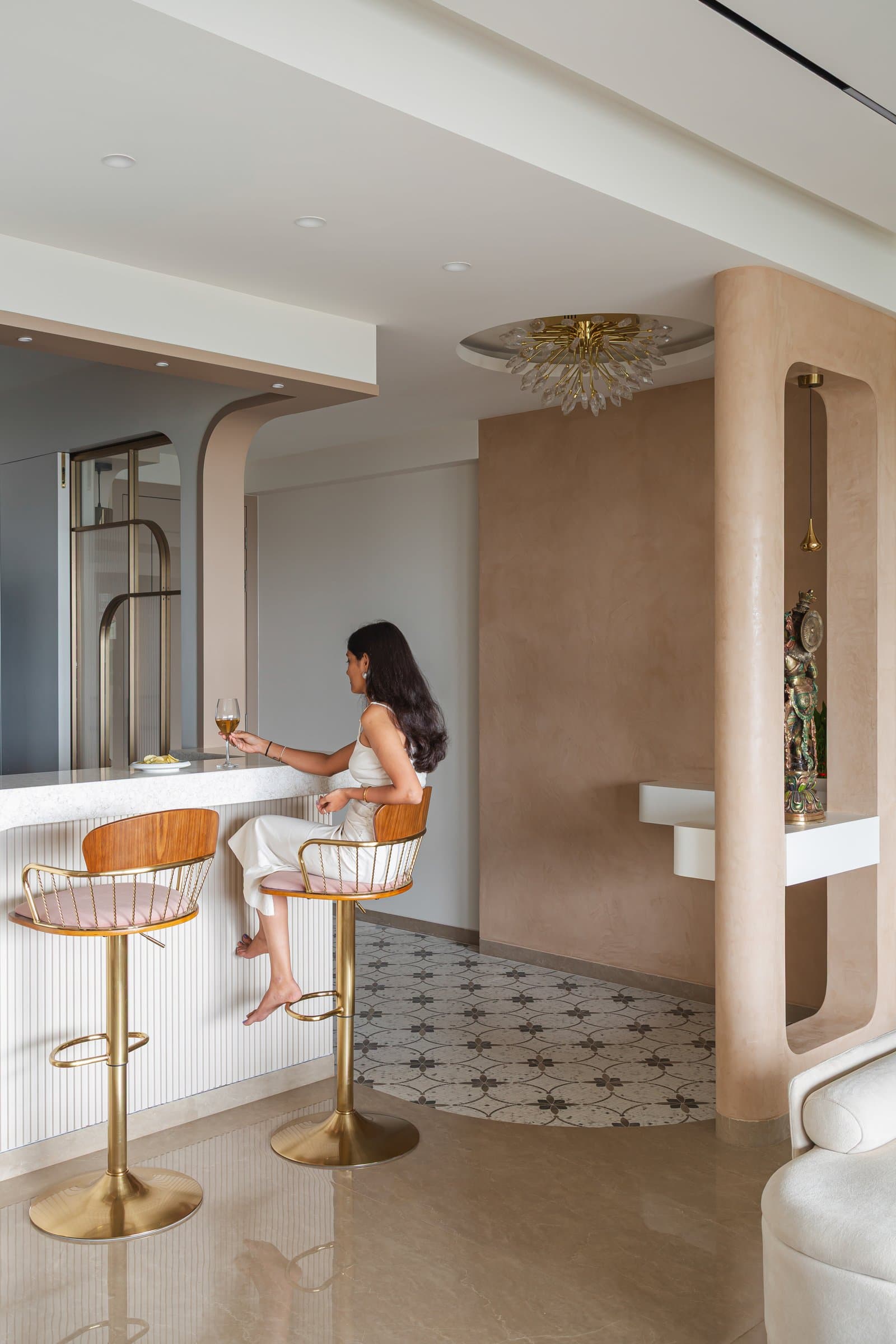 The breakfast counter, a curved ribbed volume that connects kitchen and living without closing either off