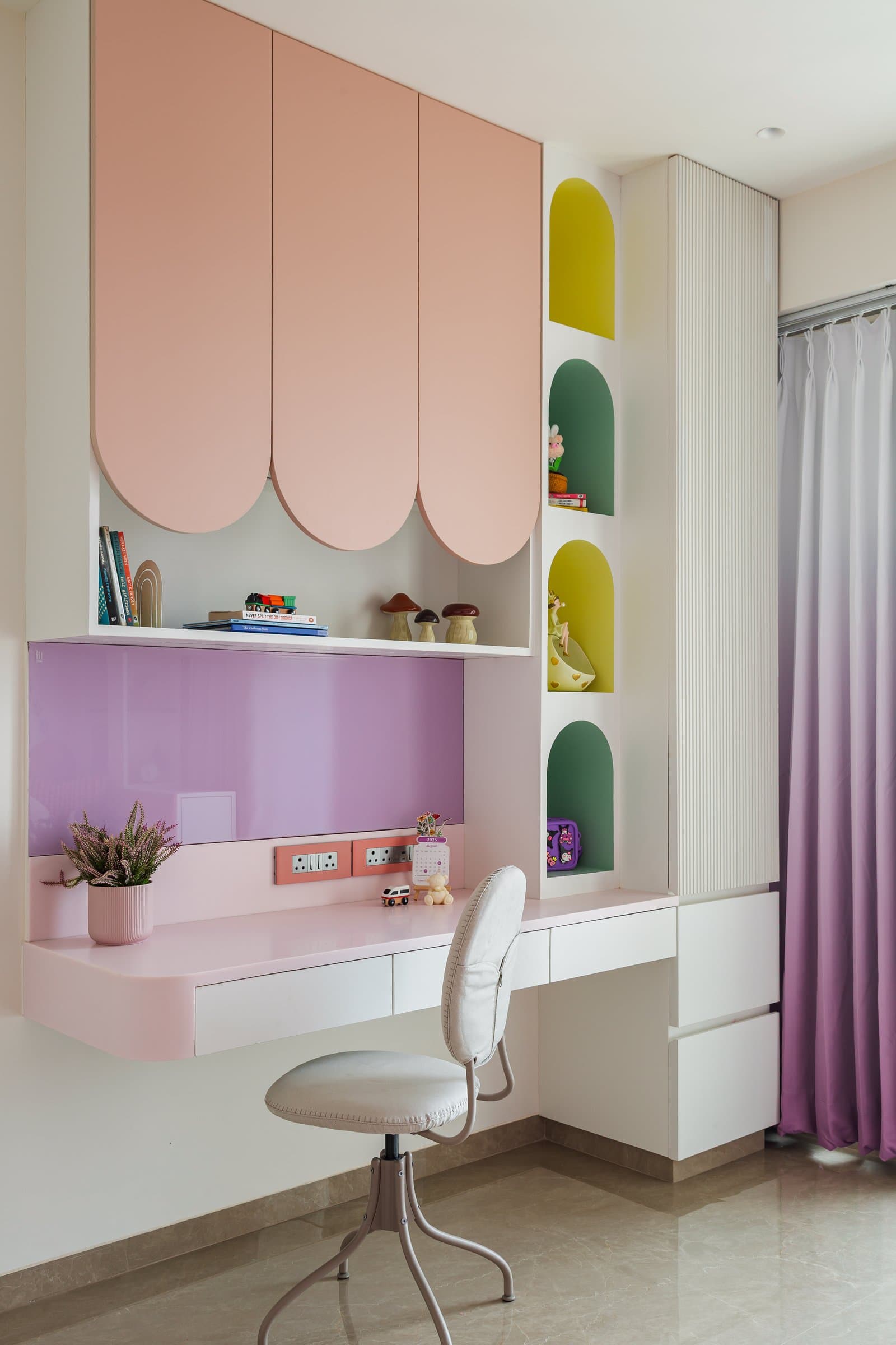 The study niche, with scalloped shutters and arched colour-blocked recesses extending the room's playful language